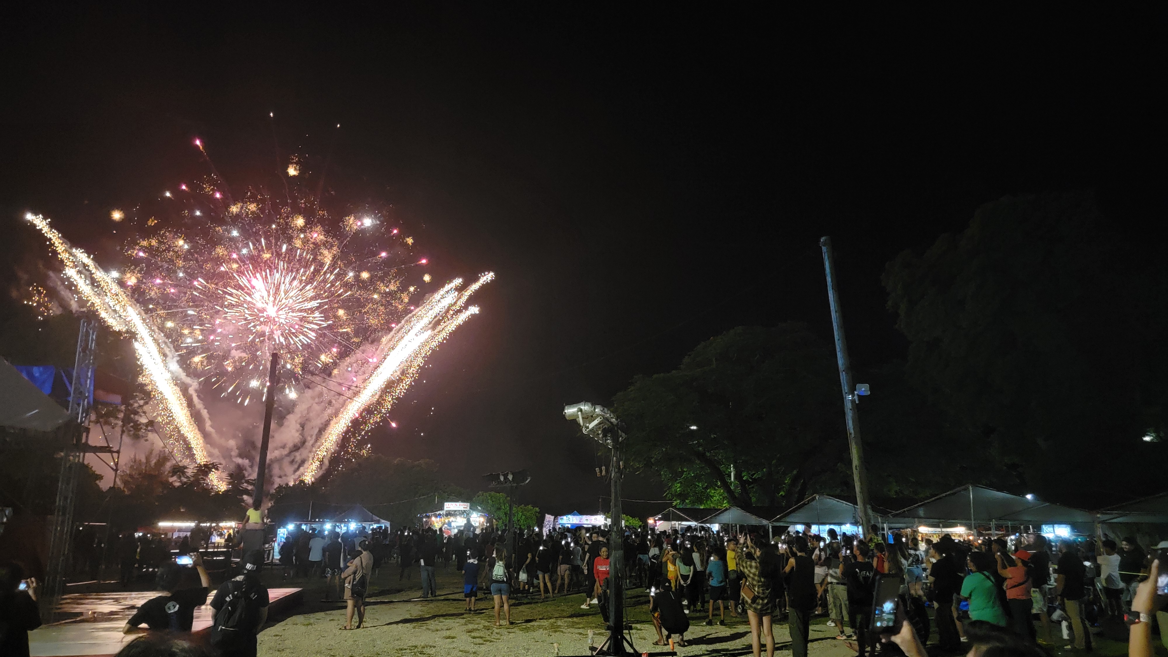 Community members and visitors watch the fireworks show that highlighted the closing ceremony of the 77th Liberation Day festivities on Saturday at Garapan Fishing Base.