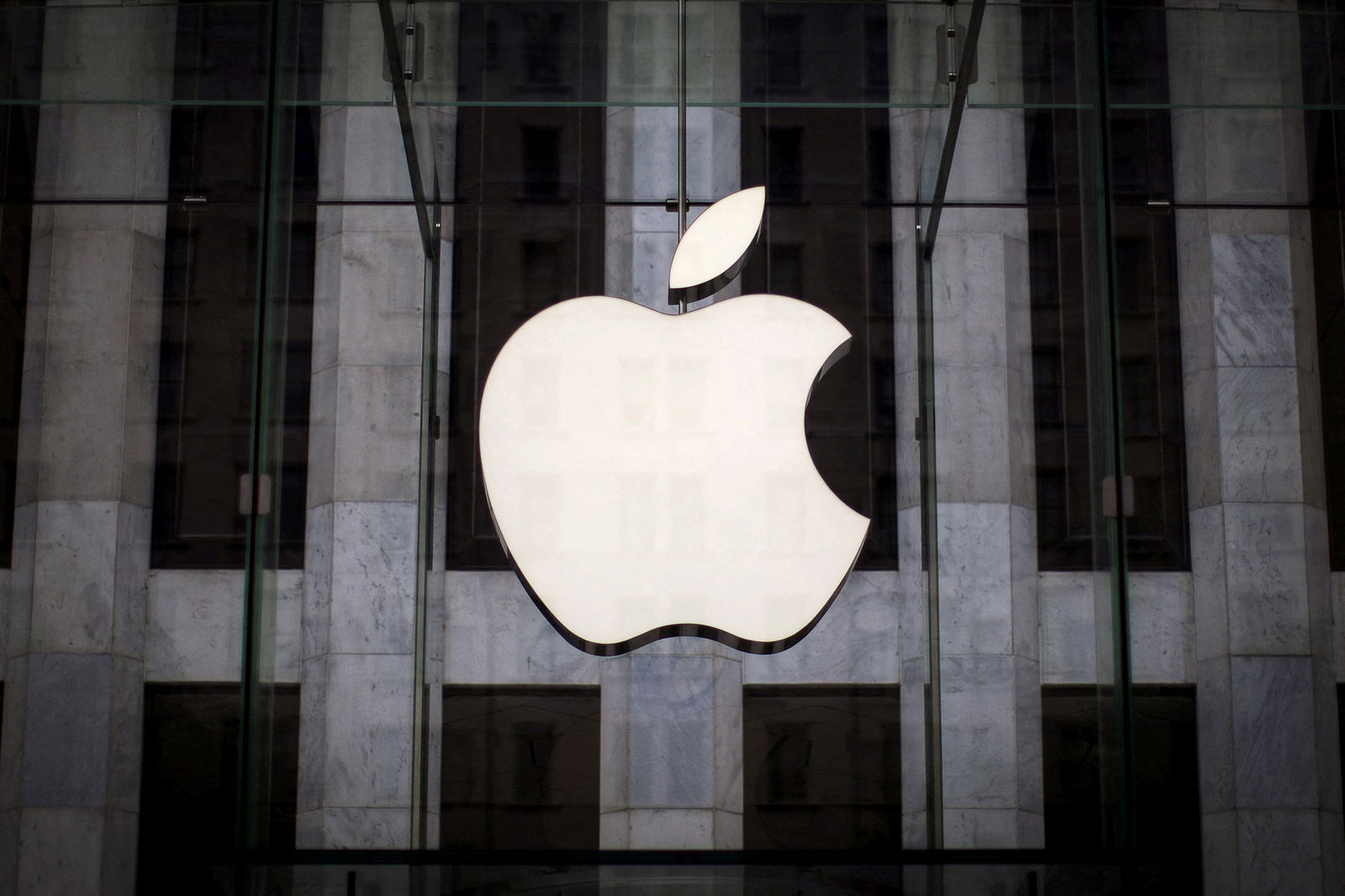 An Apple logo hangs above the entrance to the Apple store on 5th Avenue in the Manhattan borough of New York City, July 21, 2015.