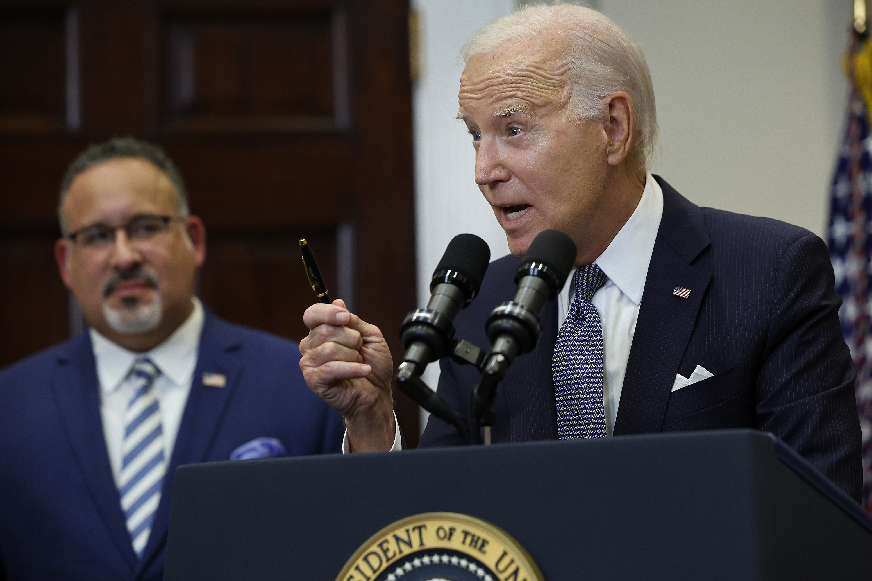 President Joe Biden, right, is joined by Education Secretary Miguel Cardona as he announces new actions to protect borrowers after the Supreme Court struck down his student loan forgiveness plan in the Roosevelt Room at the White House on Friday, June 30, 2023, in Washington, D.C. (Chip Somodevilla/Getty Images/TNS)