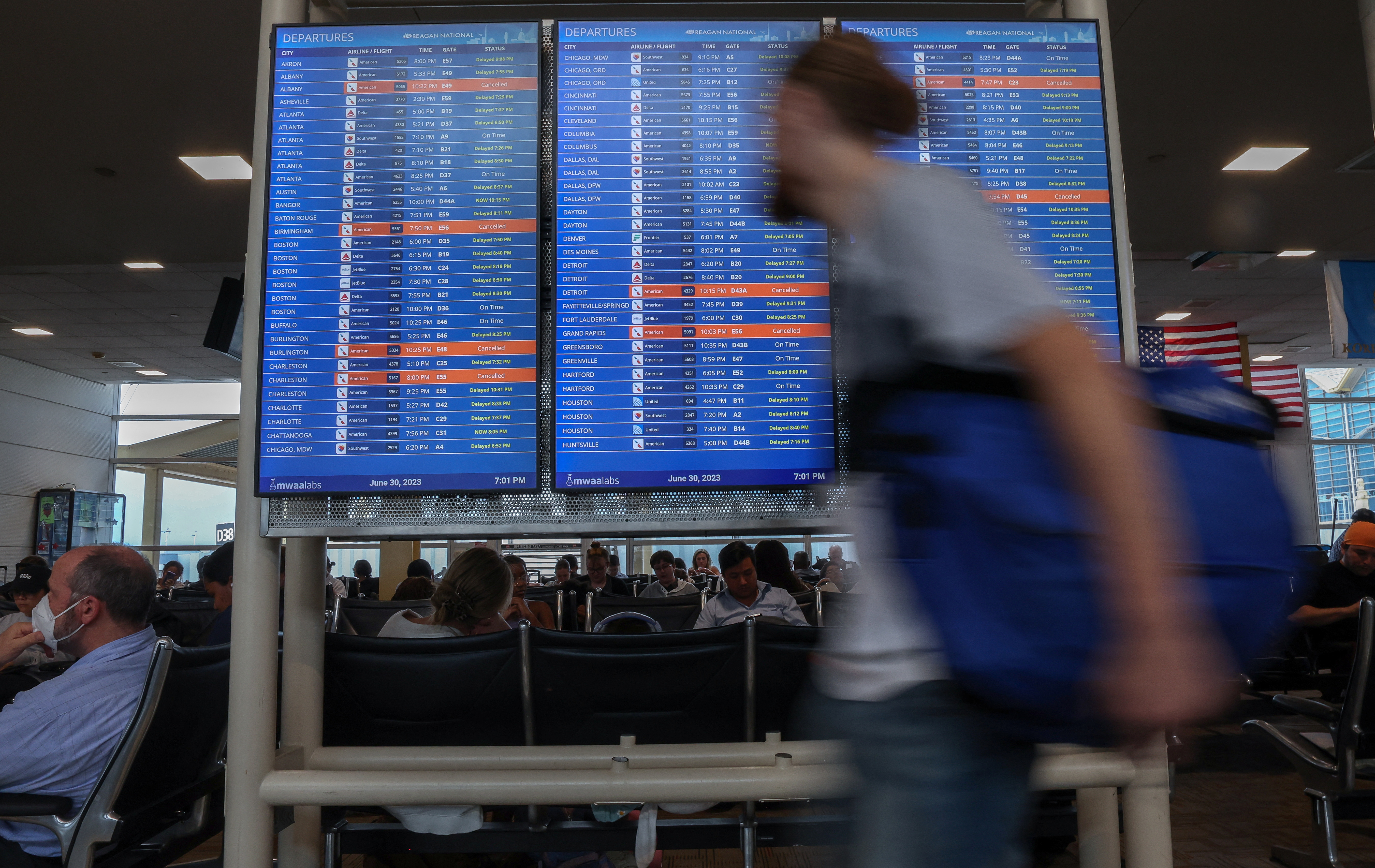 Travelers check the status of their flights ahead of the July 4th holiday weekend at Ronald Reagan Washington National Airport in Arlington, Virginia, U.S., June 30, 2023. REUTERS/Evelyn Hockstein