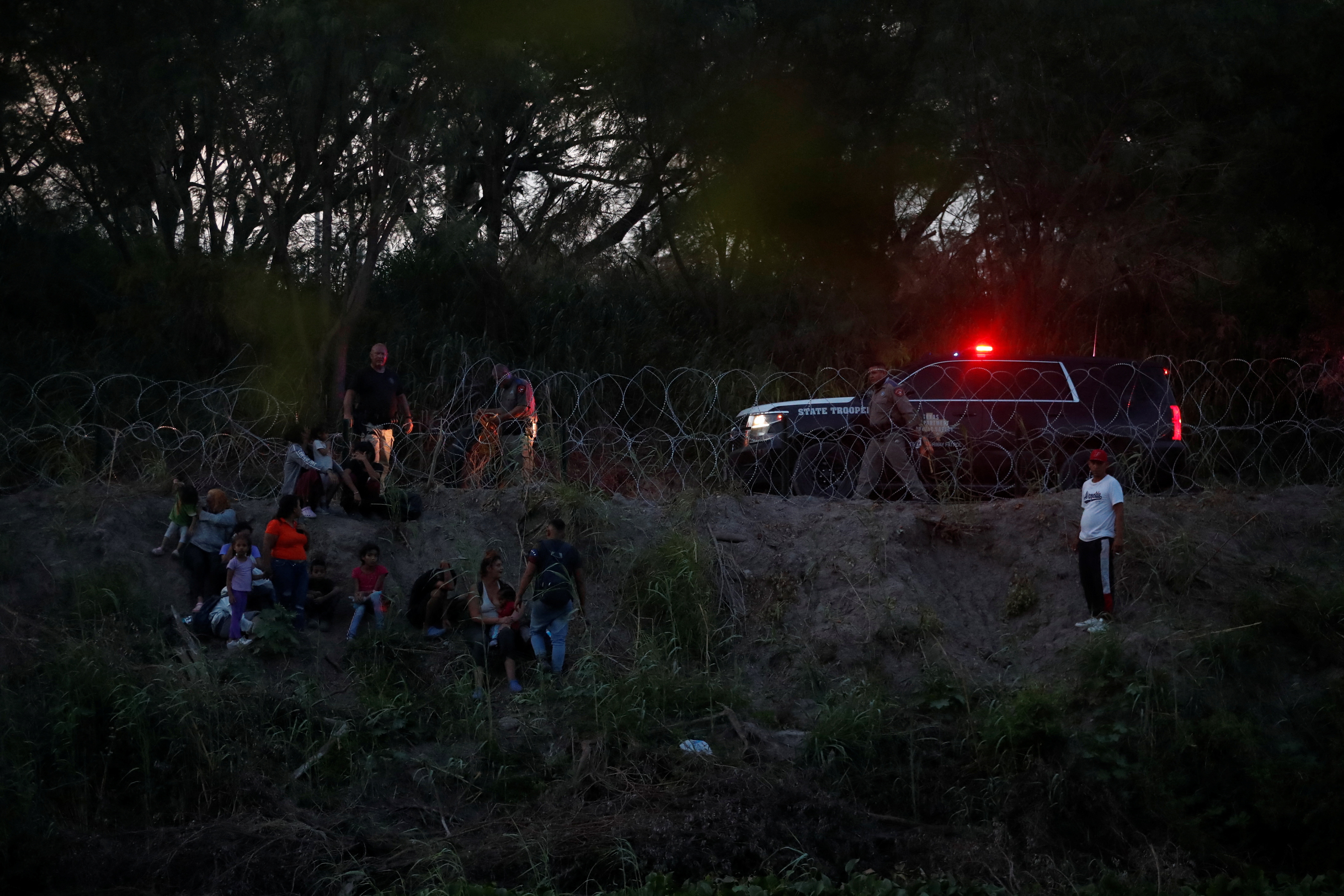 Asylum seekers gather after crossing the Rio Grande river in an attempt to enter the United States, as seen from Matamoros, at a makeshift camp, in Matamoros, Mexico June 21, 2023. REUTERS/Daniel Becerril/File Photo
