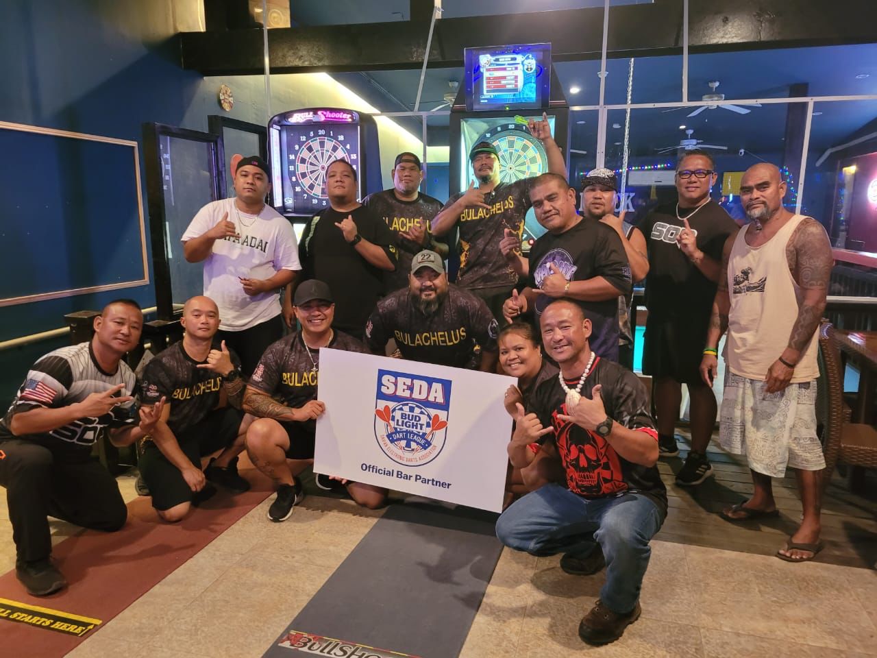 The Flamingo Bulachelus and Black 8 Kalakas players pose for a photo after their game Tuesday in the Tuesday B Latte Stone Division of the 2023 SEDA Bud Light Dart League at Black 8 Pool Bar.