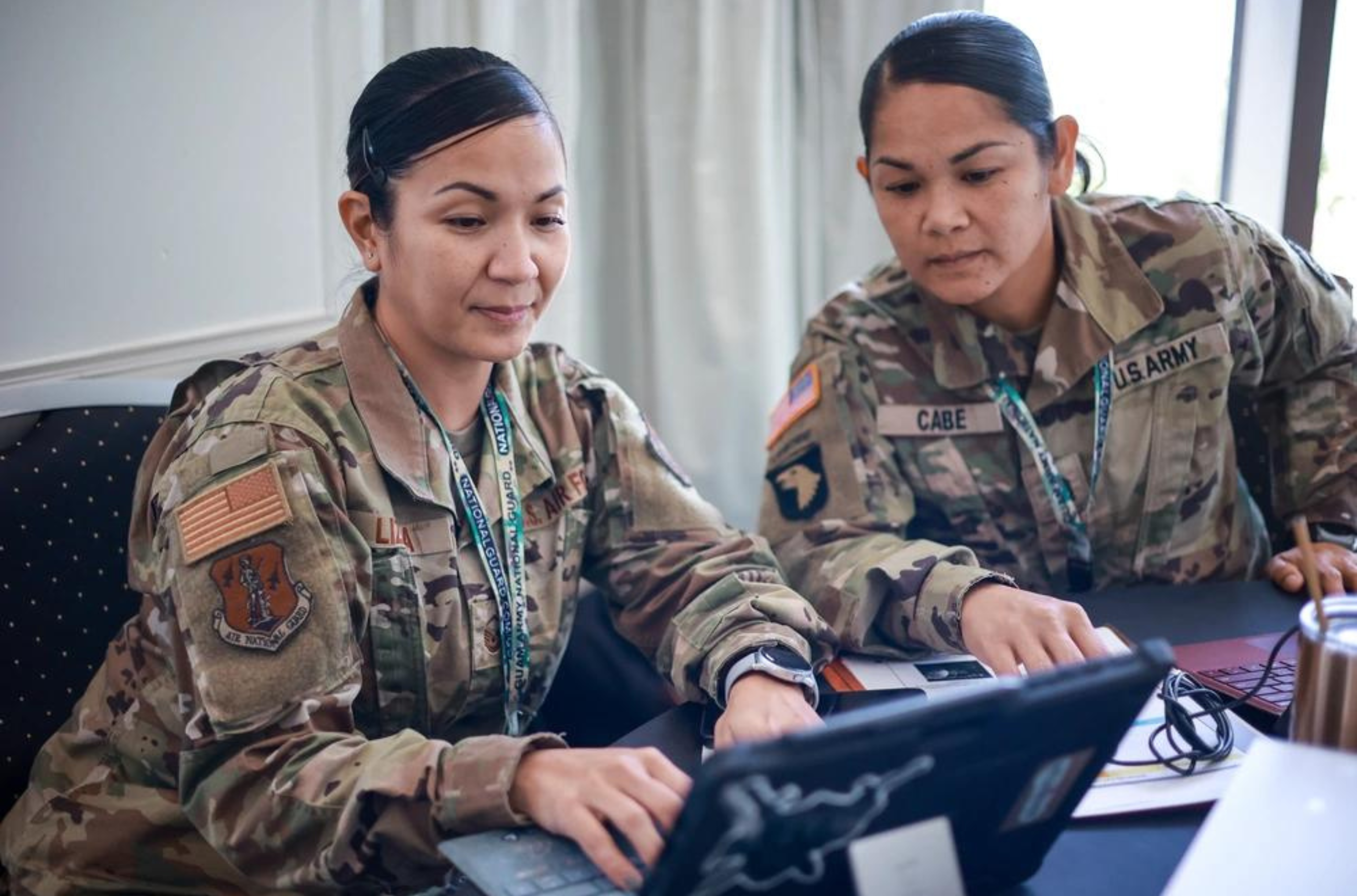 U.S. Air Force Master Sgt. Christine Lizama, left, and U.S. Army Sgt. 1st Class Jolina Cabe, both assigned to the Guam National Guard, attend a Cyber Conference on Guam, on July 18.