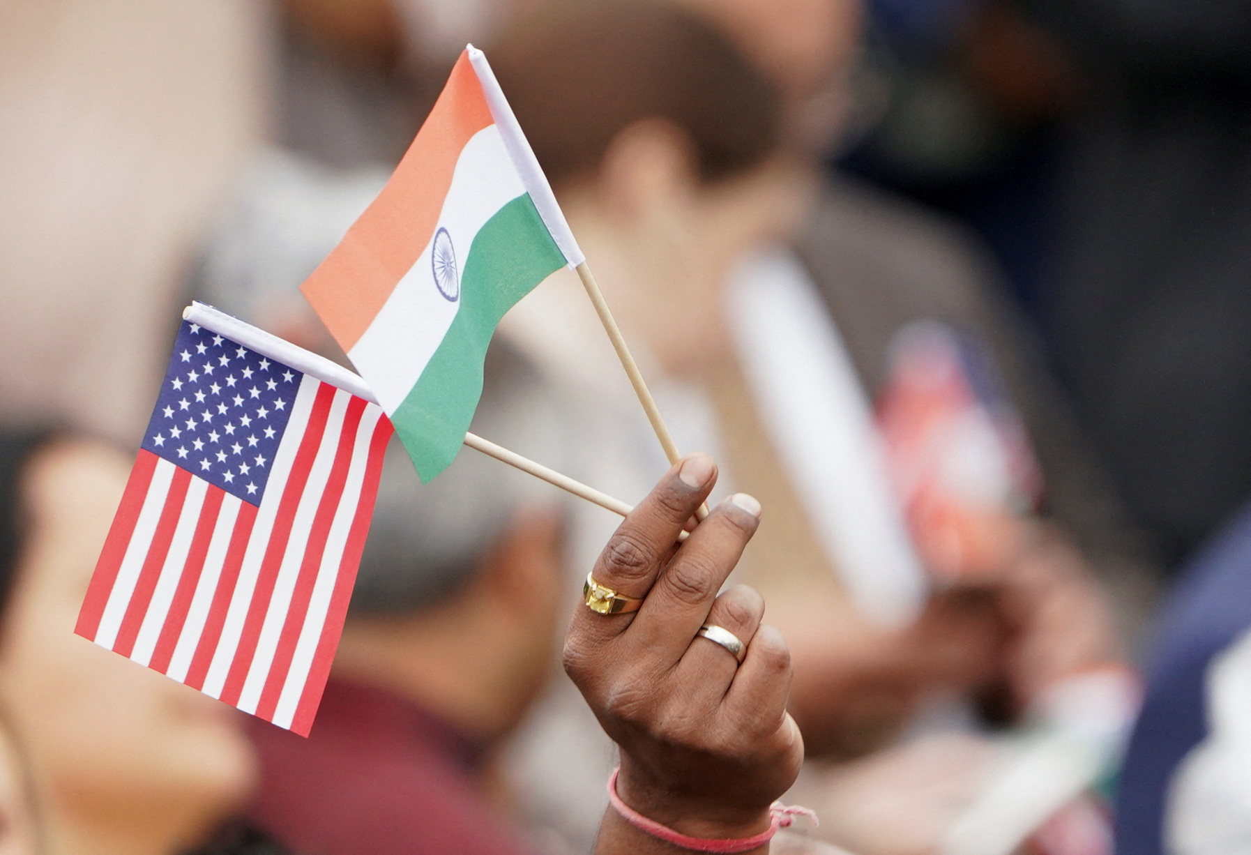 An attendee holds U.S. and India's flags as they gather on the South Lawn of the White House to watch an official State Arrival ceremony as U.S. President Joe Biden hosts India's Prime Minister Narendra Modi for a State Visit at the White House in Washington, U.S., June 22, 2023. REUTERS/Kevin Lamarque/file Photo