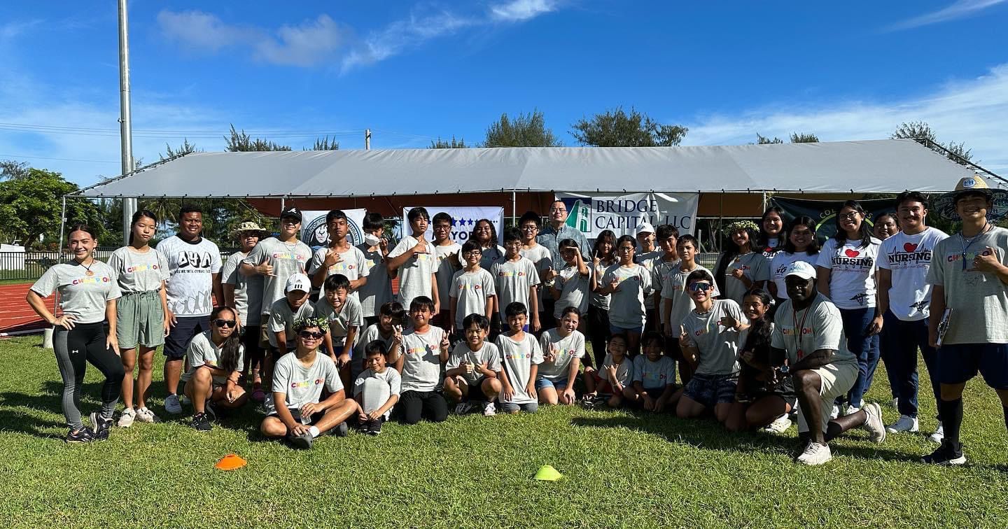 Participants of the Youth Summer Sports Blitz pose  for a photo with House Speaker Edmund Villagomez at the Oleai Sports Complex.