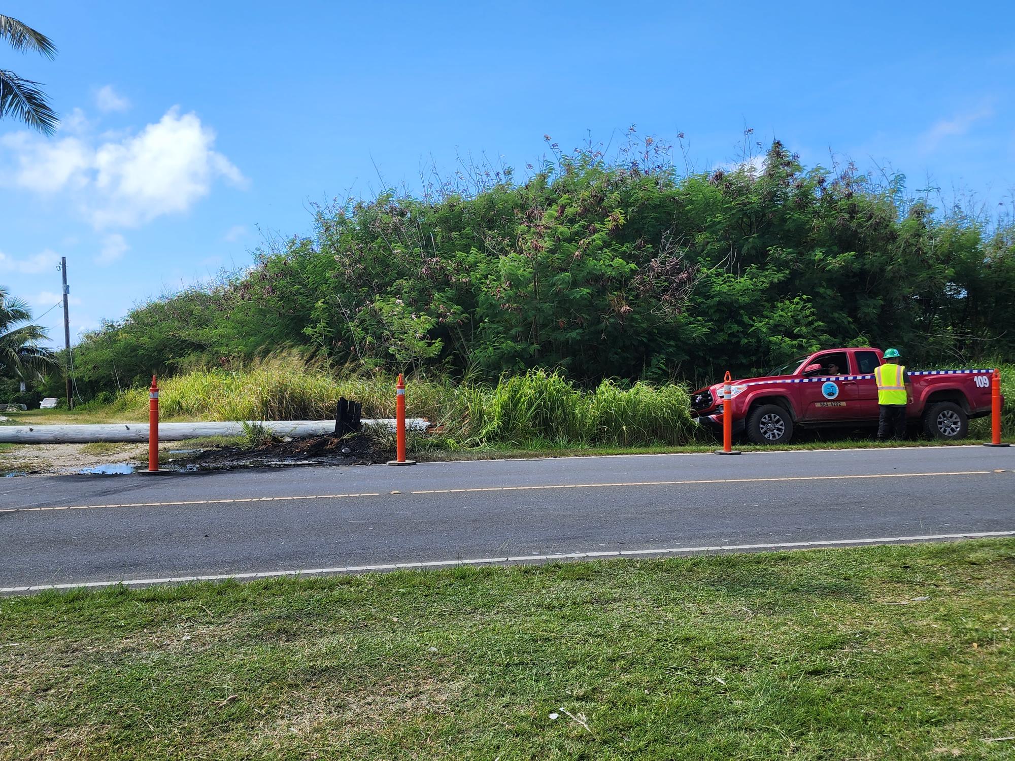 Commonwealth Utilities Corp. personnel are seen in the area to assess the damage to the power pole.