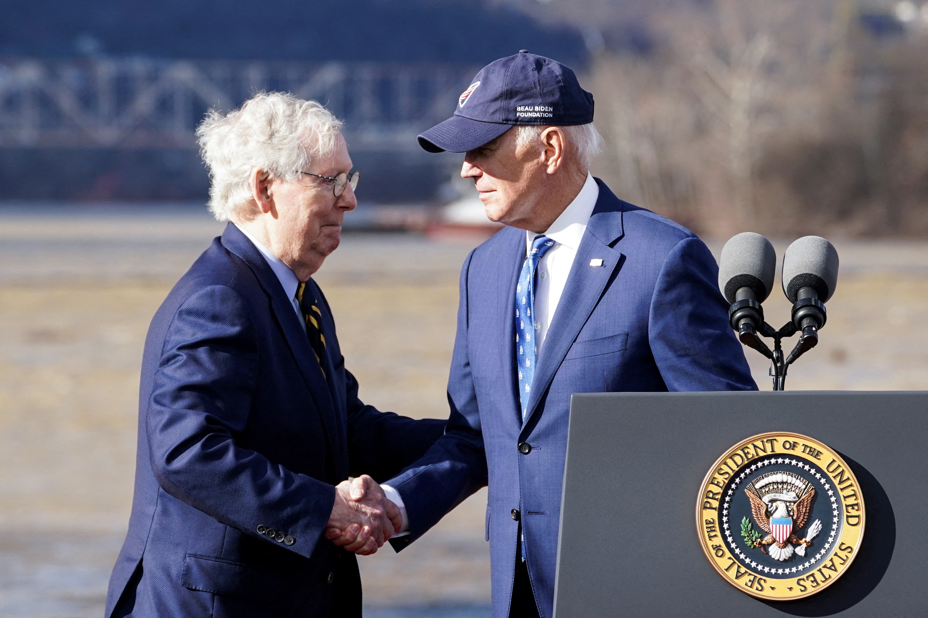 U.S. President Joe Biden shakes hands with U.S. Senate Republican Leader Mitch McConnell (R-KY) during an event to tout the new Brent Spence Bridge over the Ohio River between Covington, Kentucky and Cincinnati, Ohio near the bridge in Covington, Kentucky, U.S., January 4, 2023. REUTERS/Kevin Lamarque/File Photo