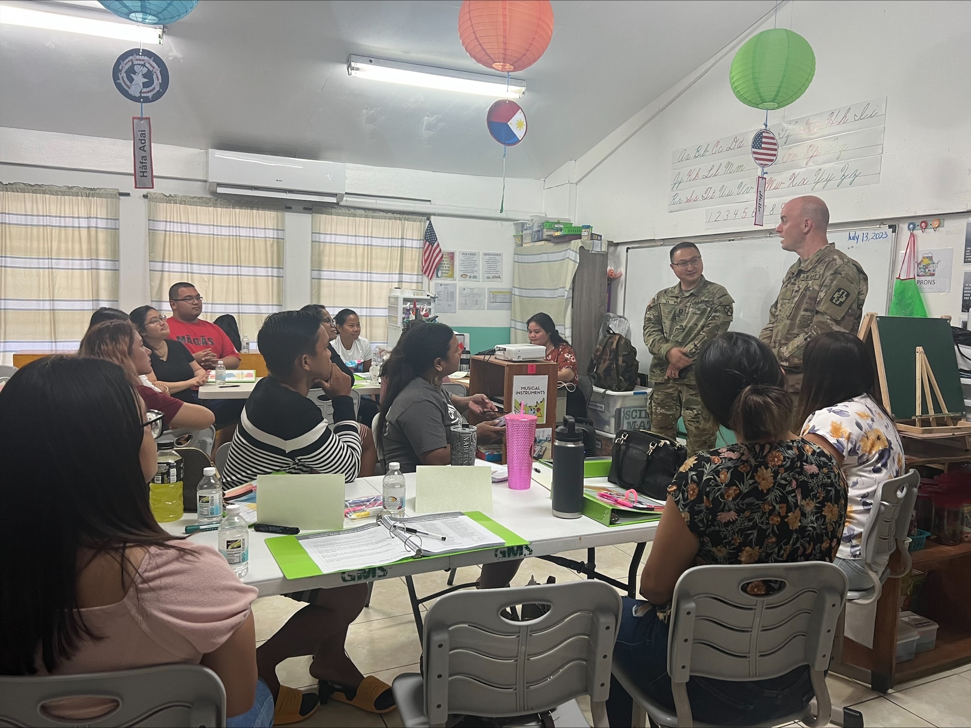 Maj. Caleb Ra, a clinical social worker with the 1835th Med. Det., from Aurora, Co., and Maj. Bradley Smith, a psychiatric nurse practitioner with the 467th Med. Det. Combat Operational Stress Control, from Madison, Wis., met with a parenting class at Green Meadow School in Saipan during Innovative Readiness Training-Operation Wellness CNMI on July 15, 2023. Ra and Smith, members of the mission’s behavioral health team, discussed how to deal with the stress of parenting.