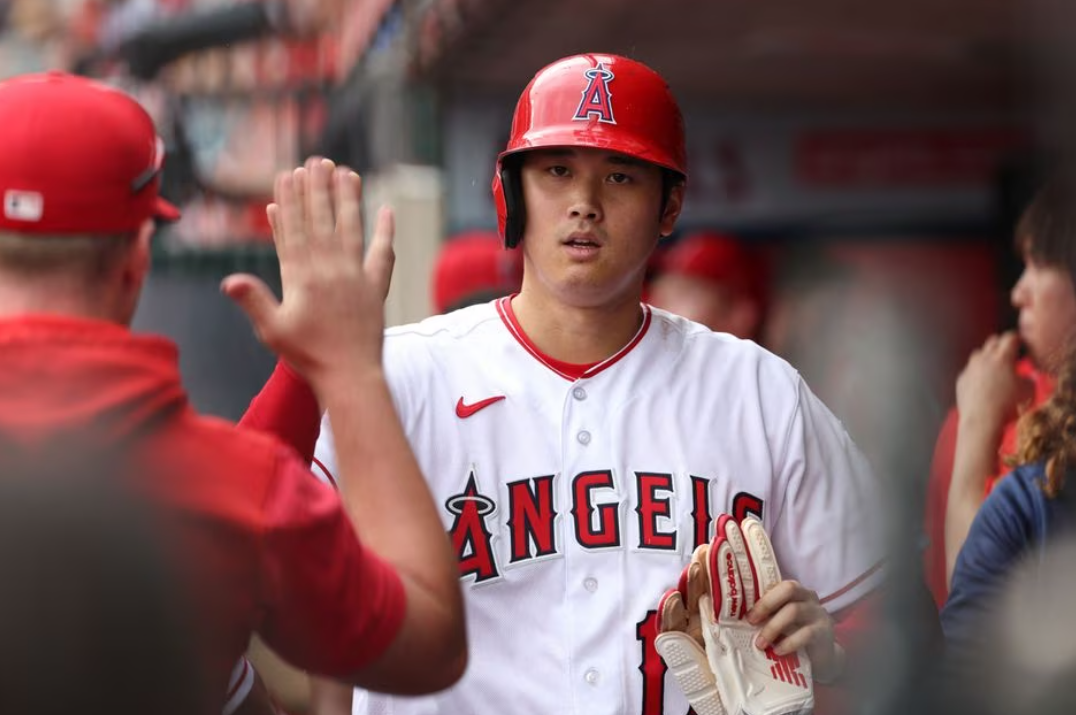 Los Angeles Angels designated hitter Shohei Ohtani (17) is greeted in the dugout after scoring a run during the fifth inning against the Pittsburgh Pirates at Angel Stadium in Anaheim, California, July 23, 2023.