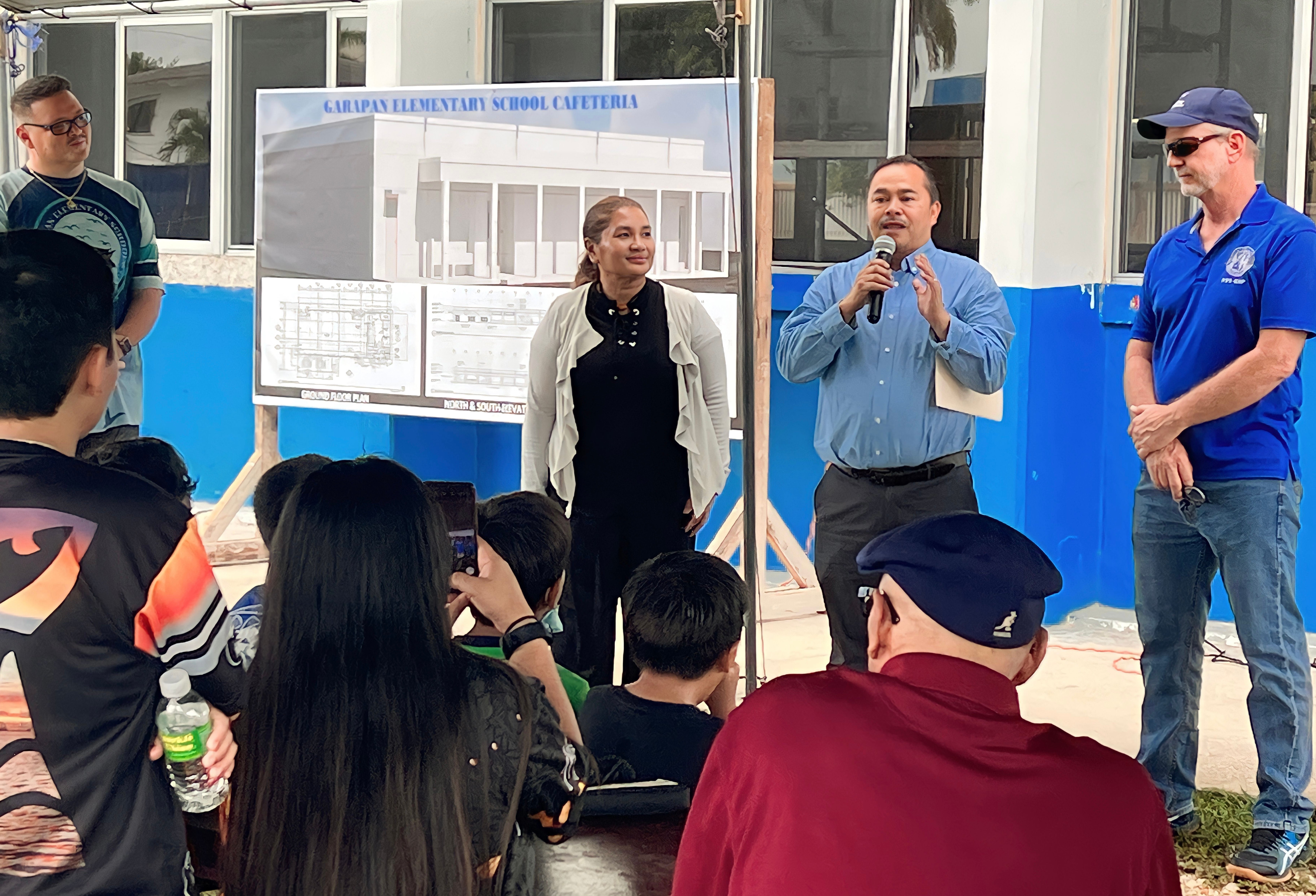 Commissioner of Education Dr. Alfred B. Ada delivers his remarks while Garapan Elementary School Principal Derwin Johnson, Public School System-Facilities Development and Management Interim Director Martha Kintol and PSS-Child Nutrition Program Director Dale Roberts look on.