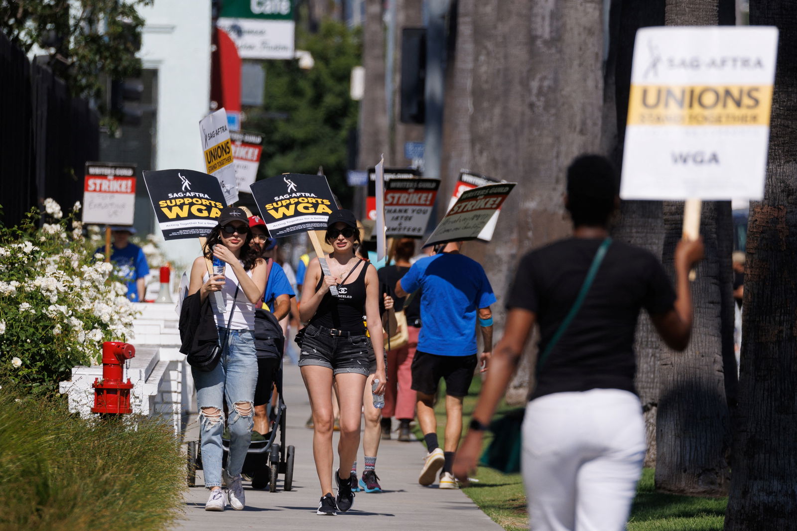 Striking Writers Guild of America (WGA) members walk the picket line in front of Netflix offices as SAG-AFTRA union announced it had agreed to a 'last-minute request' by the Alliance of Motion Picture and Television Producers for federal mediation, but it refused to again extend its existing labor contract past the 11:59 p.m. Wednesday negotiating deadline, in Los Angeles, California, U.S., July 12, 2023. REUTERS/Mike Blake