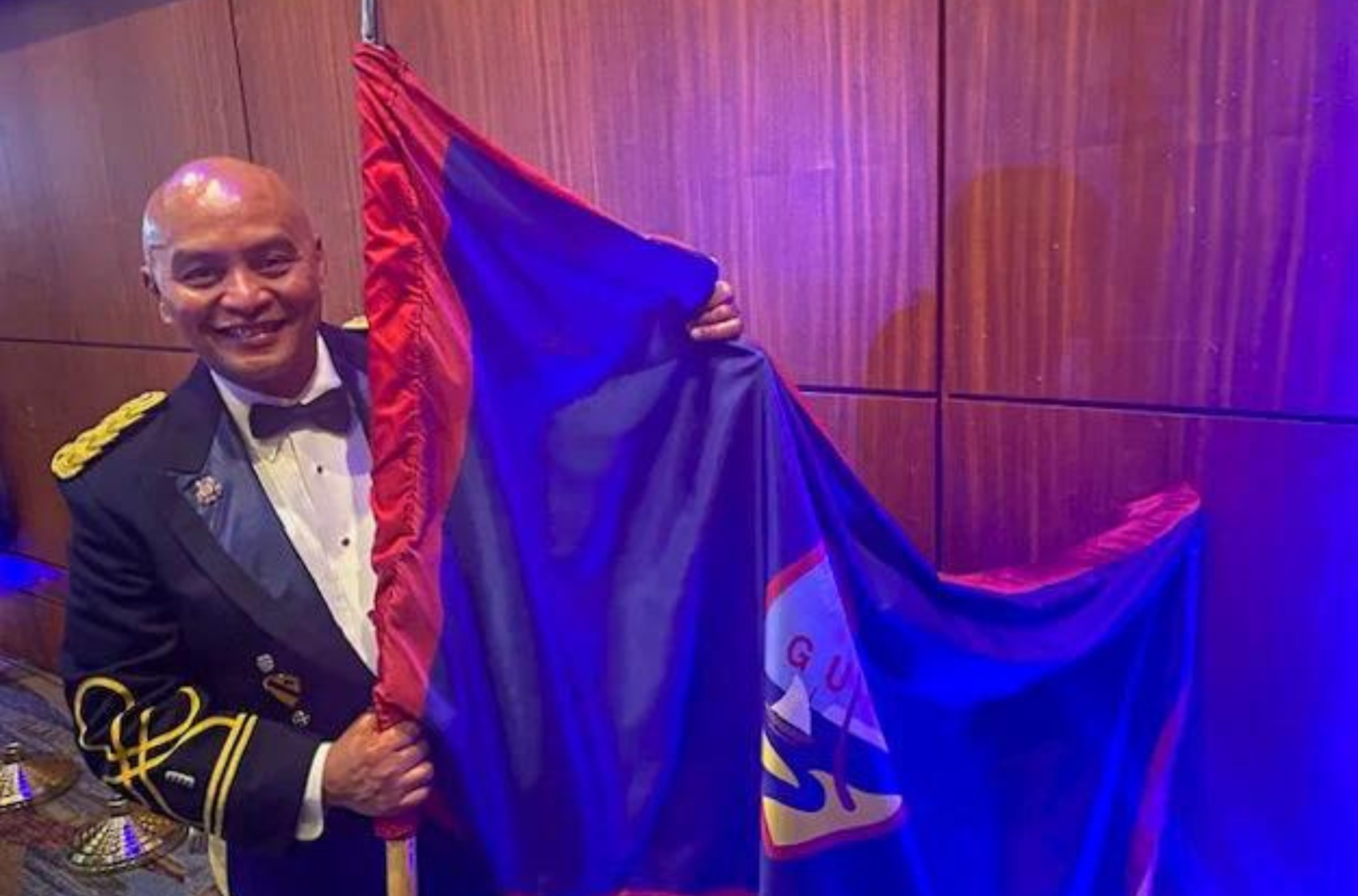 Chief Warrant Officer 4 Bernard Aguon displays the Guam flag at the National Adjutant General Ball in Columbia, S.C., June 15, 2023.