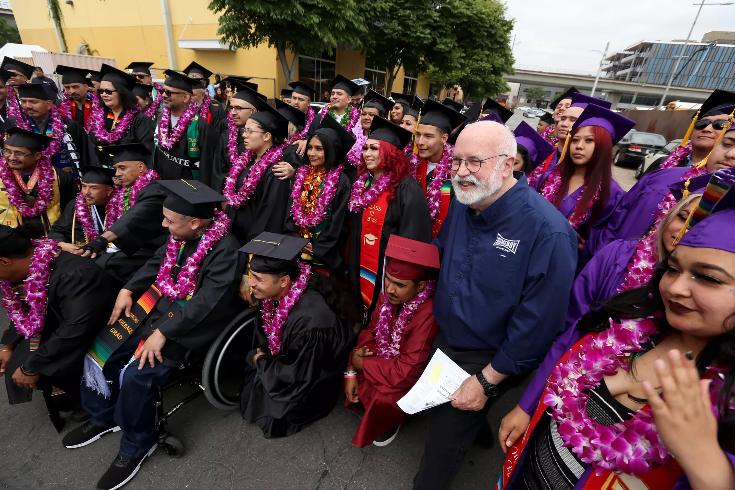 Father Greg Boyle, founder of Homeboy Industries, stands with graduates during a celebration for the Class of 2023 in Los Angeles. (Genaro Molina/Los Angeles Times/TNS)