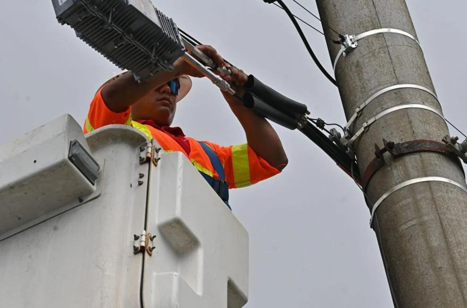 A Docomo Pacific technician works on cable lines June 13, 2023 along Route 4 in Hagåtña.