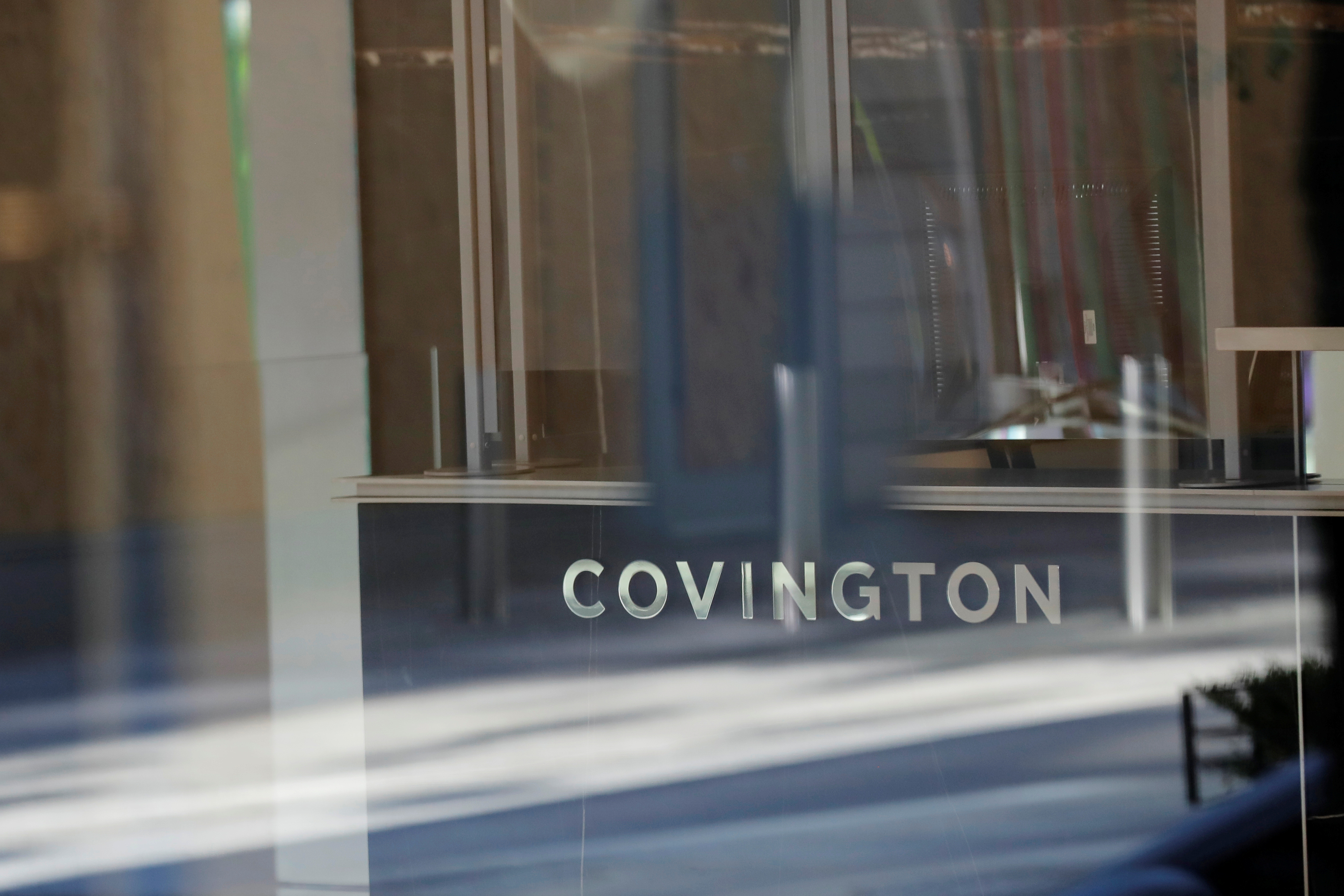 Signage is seen outside of the law firm Covington & Burling LLP in Washington, D.C., U.S., August 30, 2020. REUTERS/Andrew Kelly