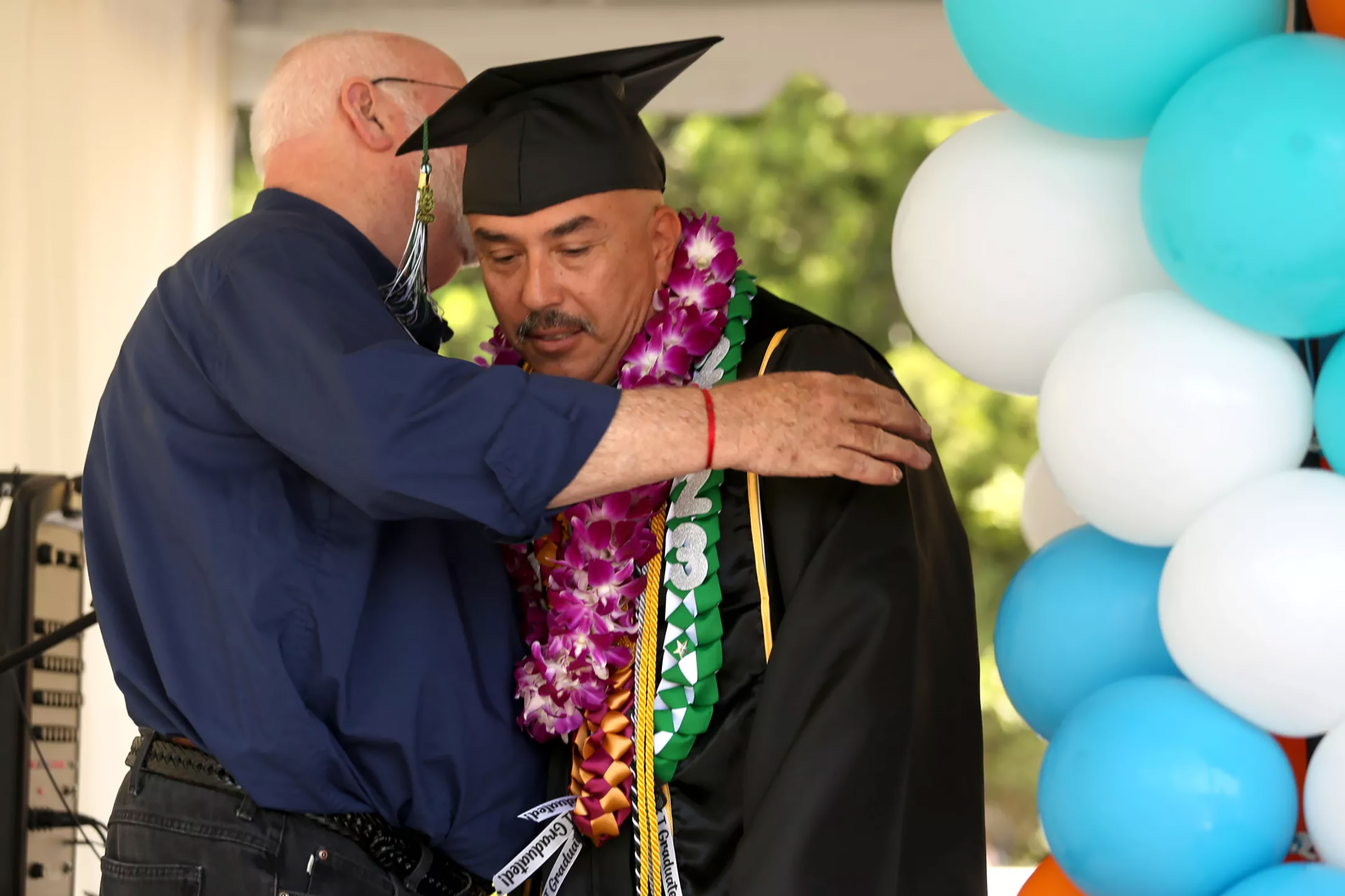 Father Greg Boyle hugs Isaac Gonzales during a celebration of graduates at Homeboy Industries. Gonzales was honored for receiving three AA degrees from East Los Angeles College. (Genaro Molina/Los Angeles Times/TNS)