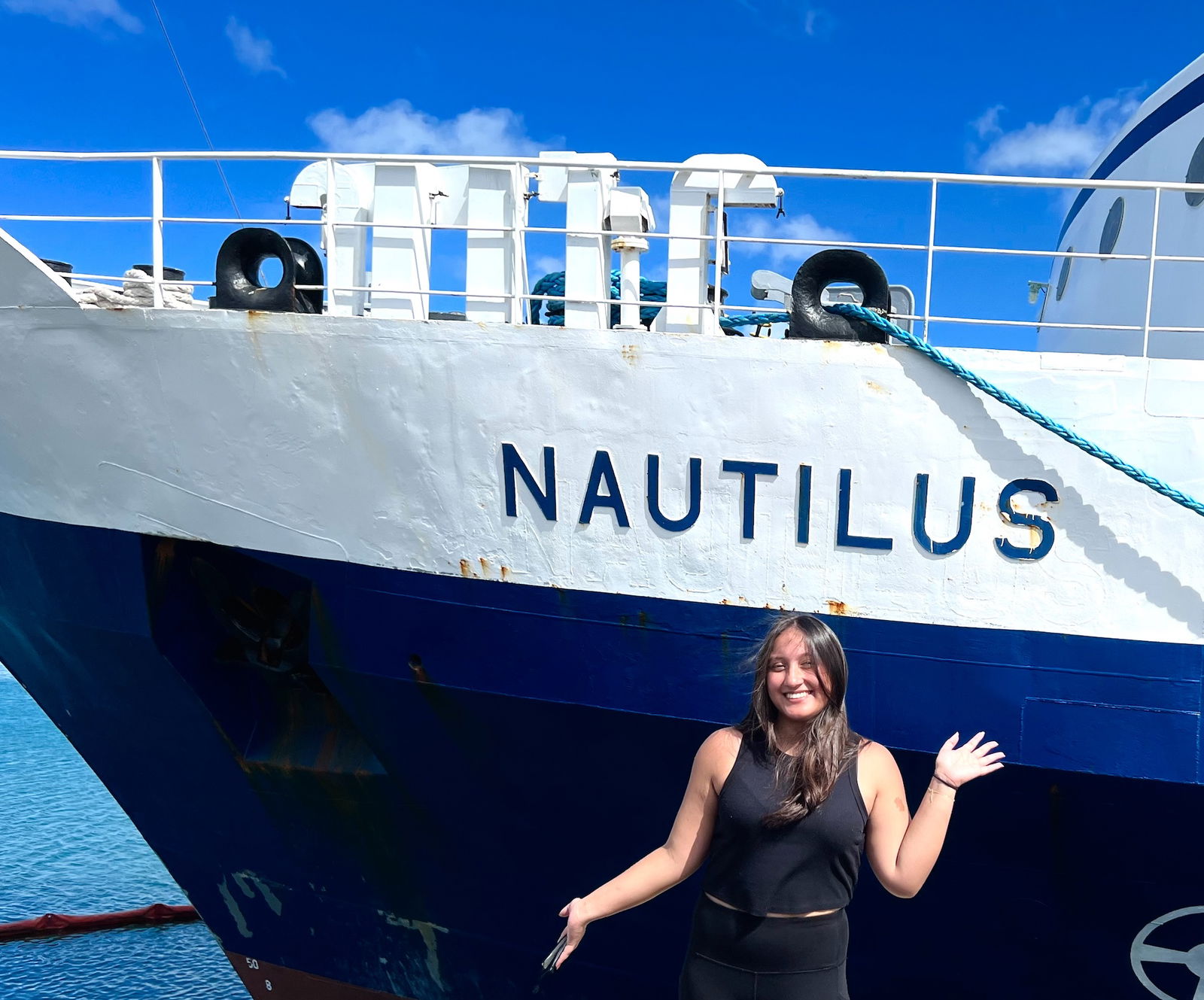 University of Guam communication major Gabriella Piper is seen with the Nautilus in the background. It set sail from Honolulu to the Canadian province of British Columbia on June 15, 2023.