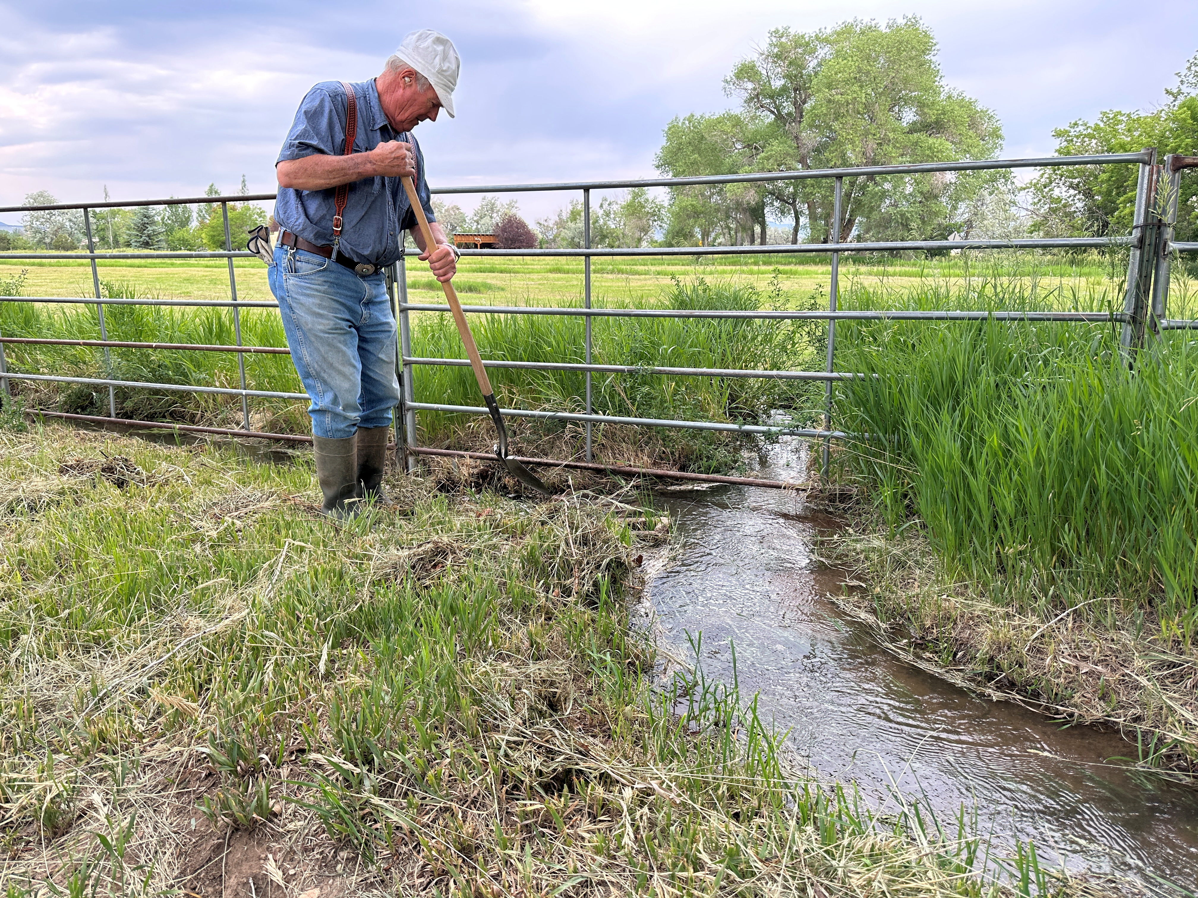 Farmer John MacArthur irrigates his fields using water from a channel running off an 'acequia' irrigation system, in Talpa, near Taos, New Mexico, U.S., June 27, 2023. REUTERS/Andrew Hay