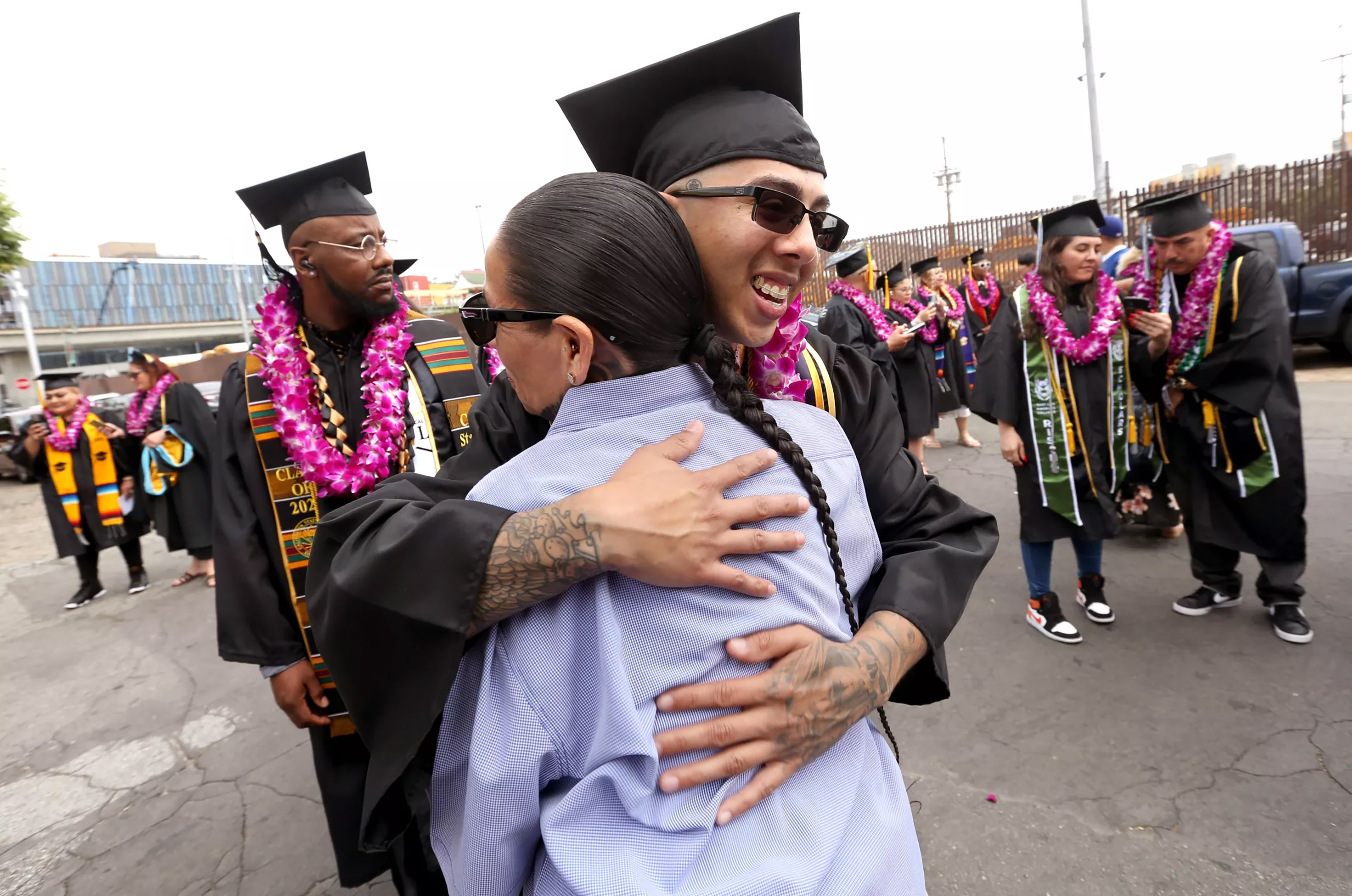 Jessi Fernandez hugs Emily Chapa after his graduation ceremony at Homeboy Industries in Los Angeles in June. (Genaro Molina/Los Angeles Times/TNS)