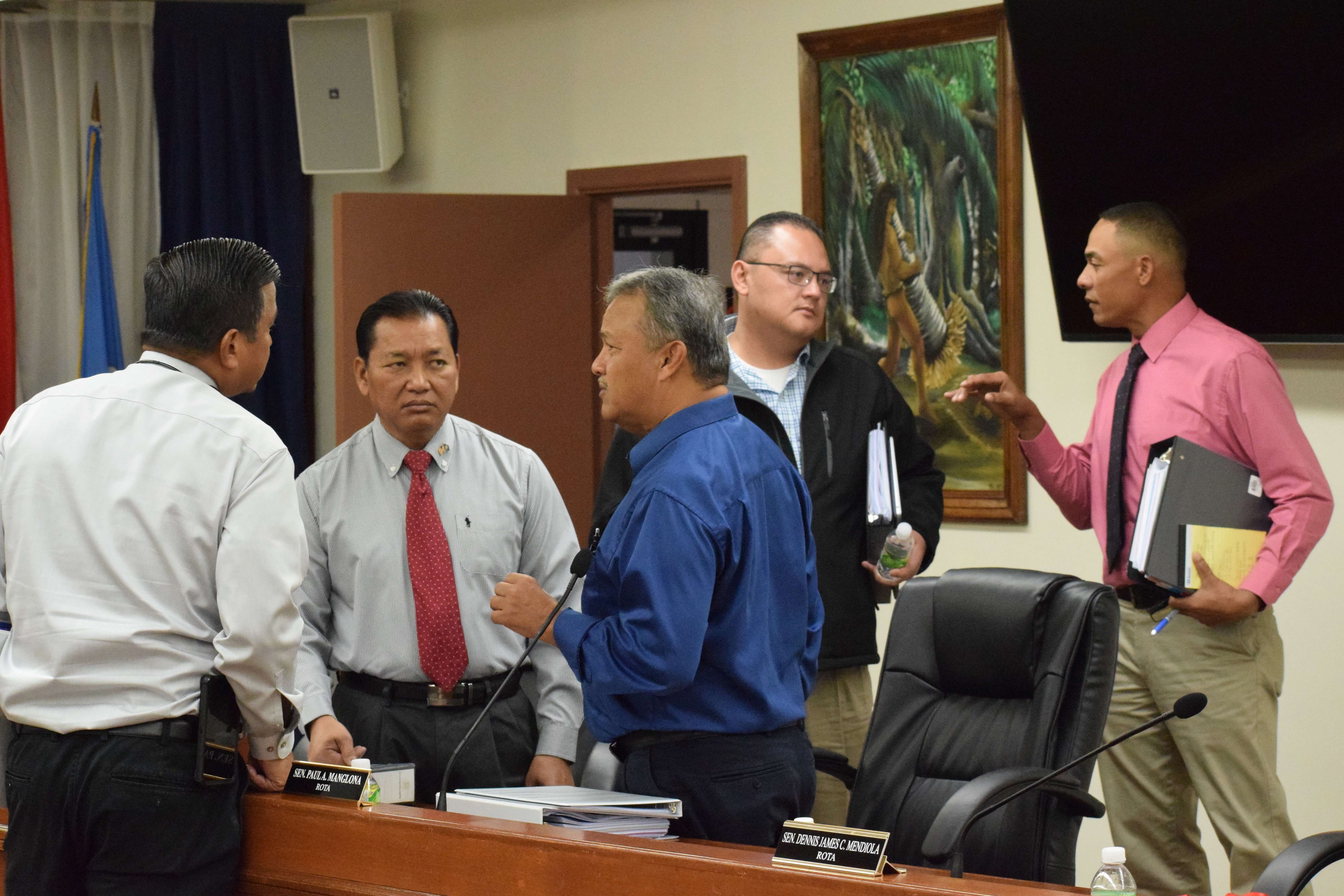 Sen. Dennis James Mendiola, right, talks with Senate Vice President Donald Manglona while Sen. Jude U. Hofschneider and Sen. Frank Q. Cruz listen to Sen. Paul A. Manglona during a break from a Senate session. 