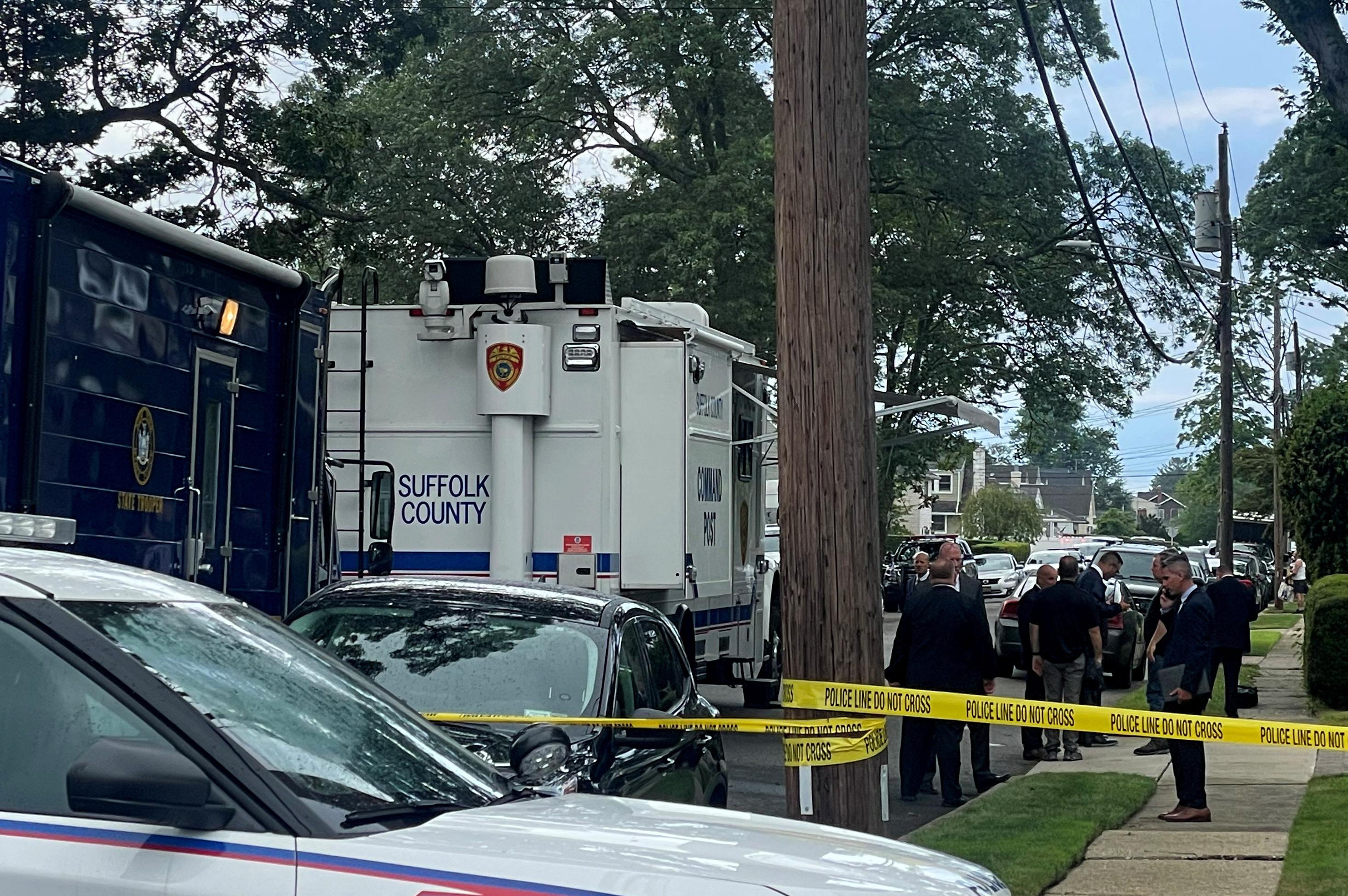Suffolk County Police and investigators are pictured near the scene of the arrest of a suspect in multiple murders of up to 10 women on Long Island in Massapequa Park, New York, U.S., July 14, 2023. REUTERS/Shannon Stapleton