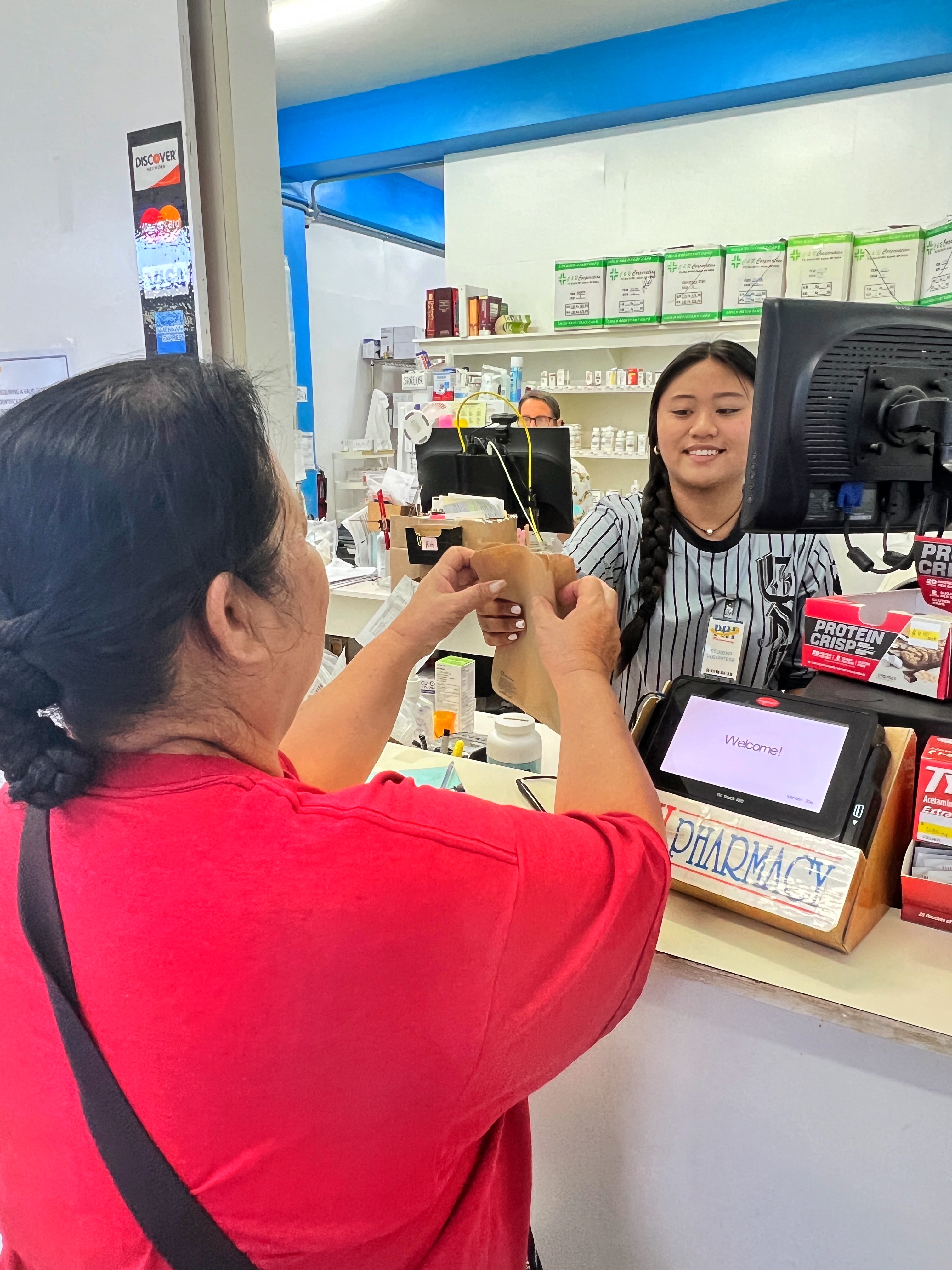 Nicola Sundiam, 15, a Kagman High School student-intern at PHI Pharmacy Kagman Branch, assists a customer. Sundiam is one of the 60 students participating in the Public School System-Saipan Chamber of Commerce local workforce summer internship program.
