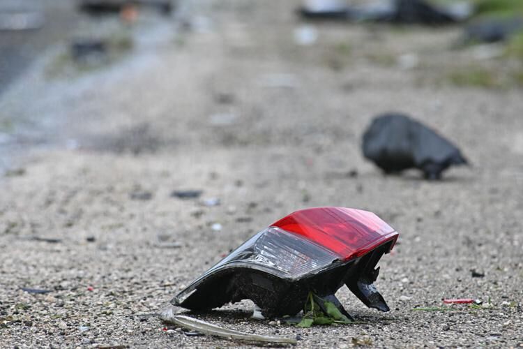 A broken taillight, shown Monday, July 17, 2023, rests on the ground after a two-car crash Sunday night in Asan.