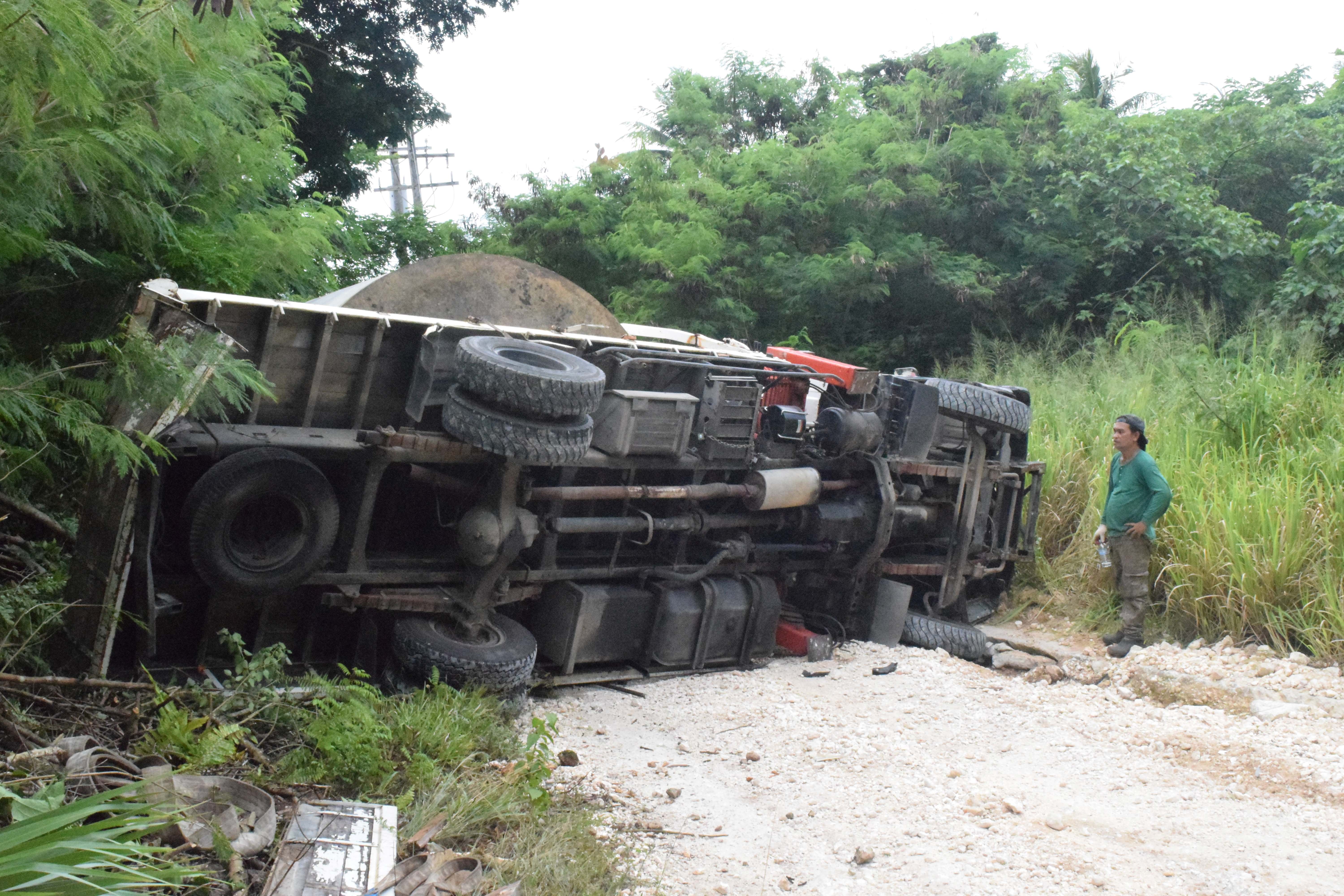 SG Auto Shop mechanic Remuel Maritano stands next to the boom truck  that overturned on Earhart Drive in Gualo Rai on July 14, 2023.