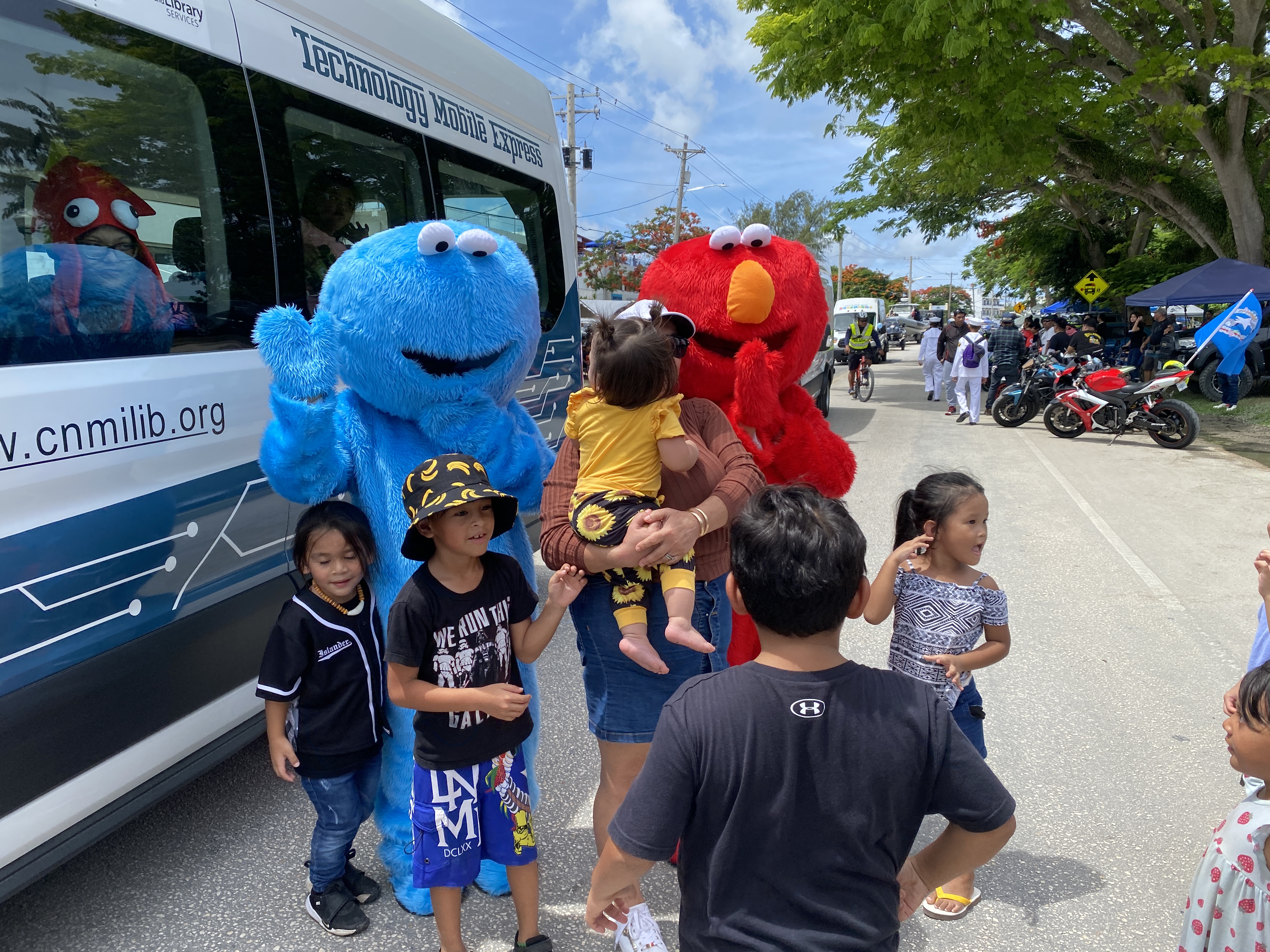 Children along the parade route were excited to take their pictures with Sesame Street characters.