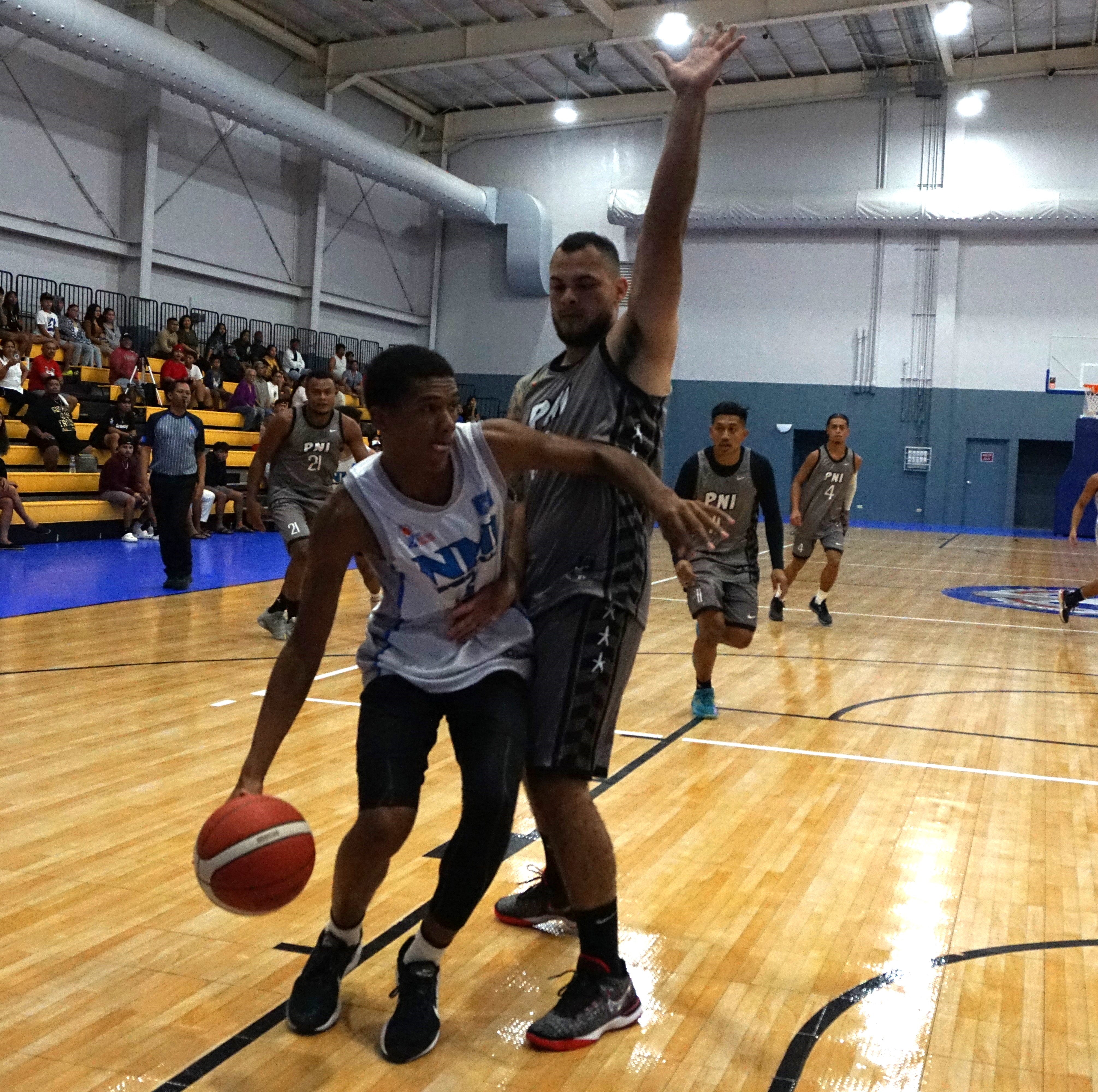 Junior Marianas' Ali Ortiz makes contact with a Pohnpei defender as he attempts to drive toward the hoop during a goodwill game Tuesday at the Ada gym.  