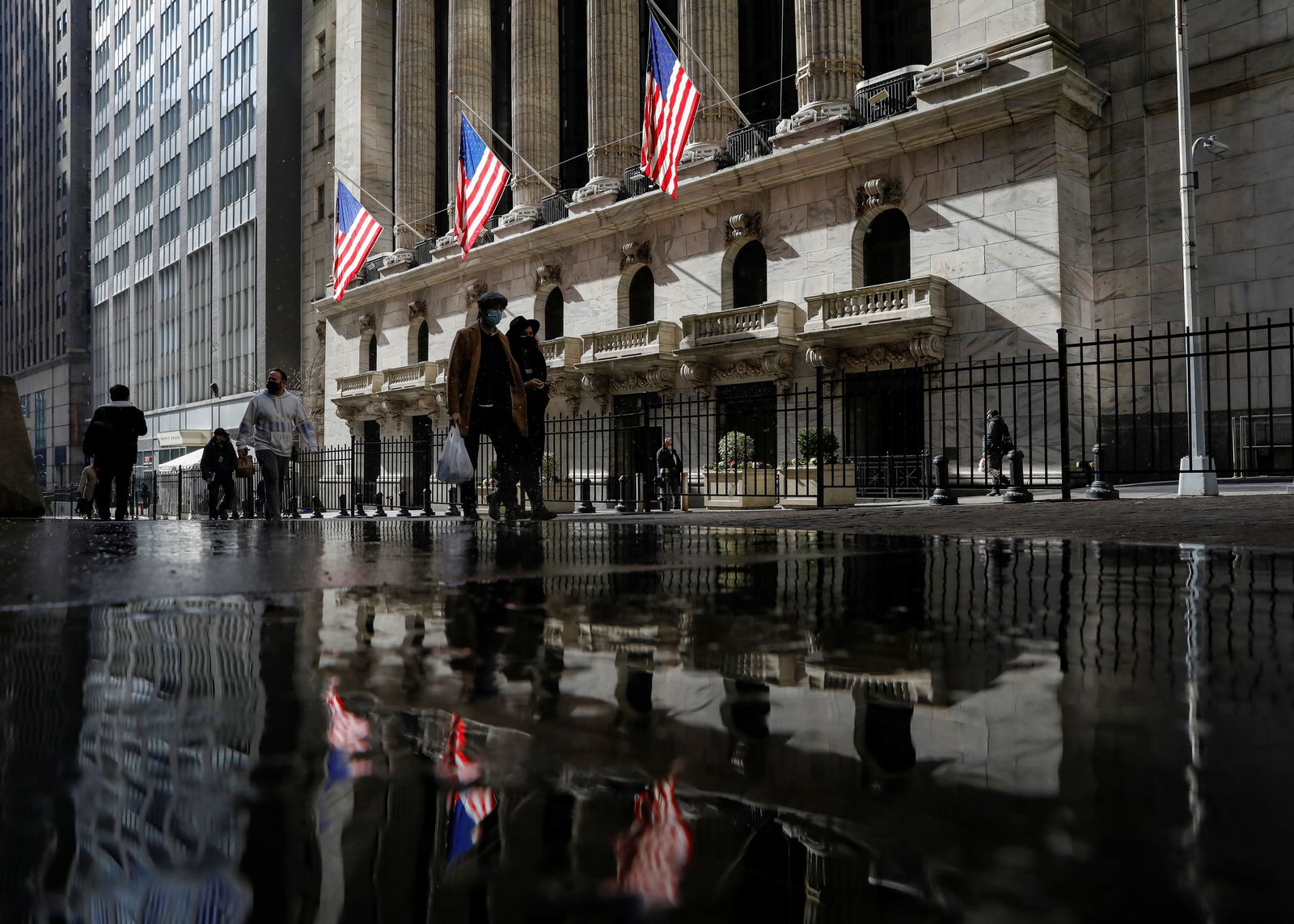 U.S. flags fly out in front of the New York Stock Exchange is seen on Feb. 16, 2021.