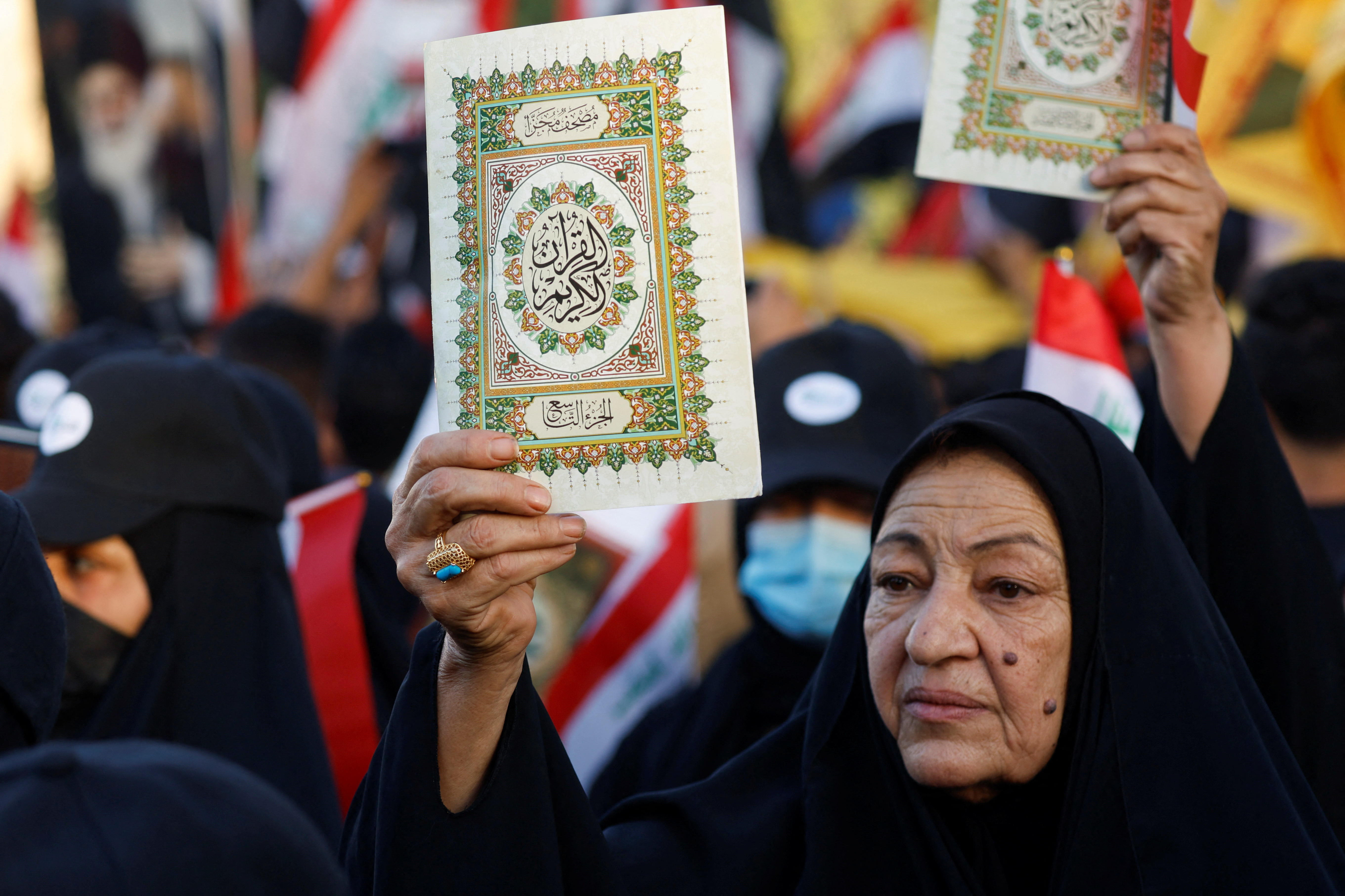 An Iraqi demonstrator holds the Koran during a protest near the Green Zone against the burning of a copy of the Koran and the Iraqi flag in the Swedish capital Stockholm, in Baghdad, Iraq July 22, 2023. REUTERS/Khalid Al-Mousily
