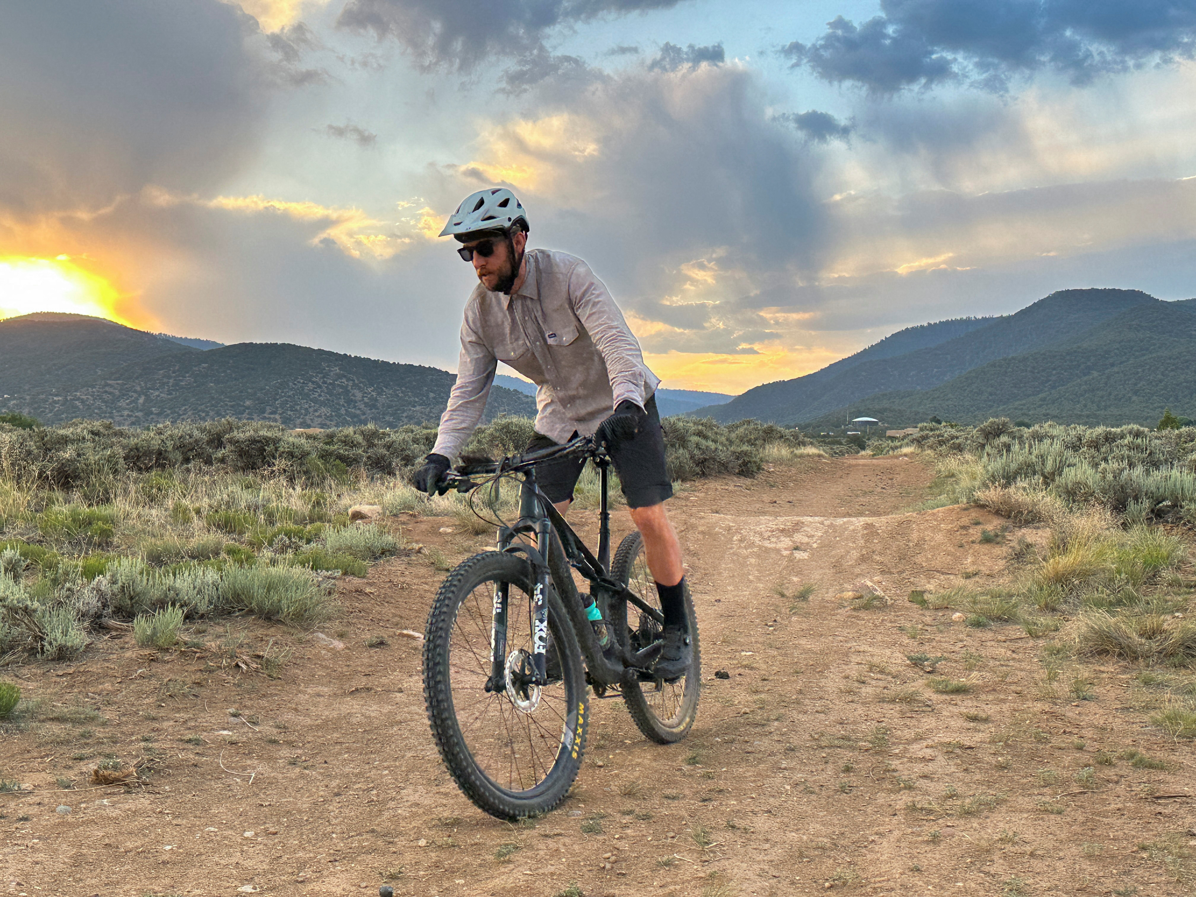 Spencer Bushnell, a mountain biker, rides in front of foothills, where the U.S. Forest Service is facing rising demand for trails and access to the national forest, in Taos, New Mexico, U.S., June 27, 2023. REUTERS/Andrew Hay