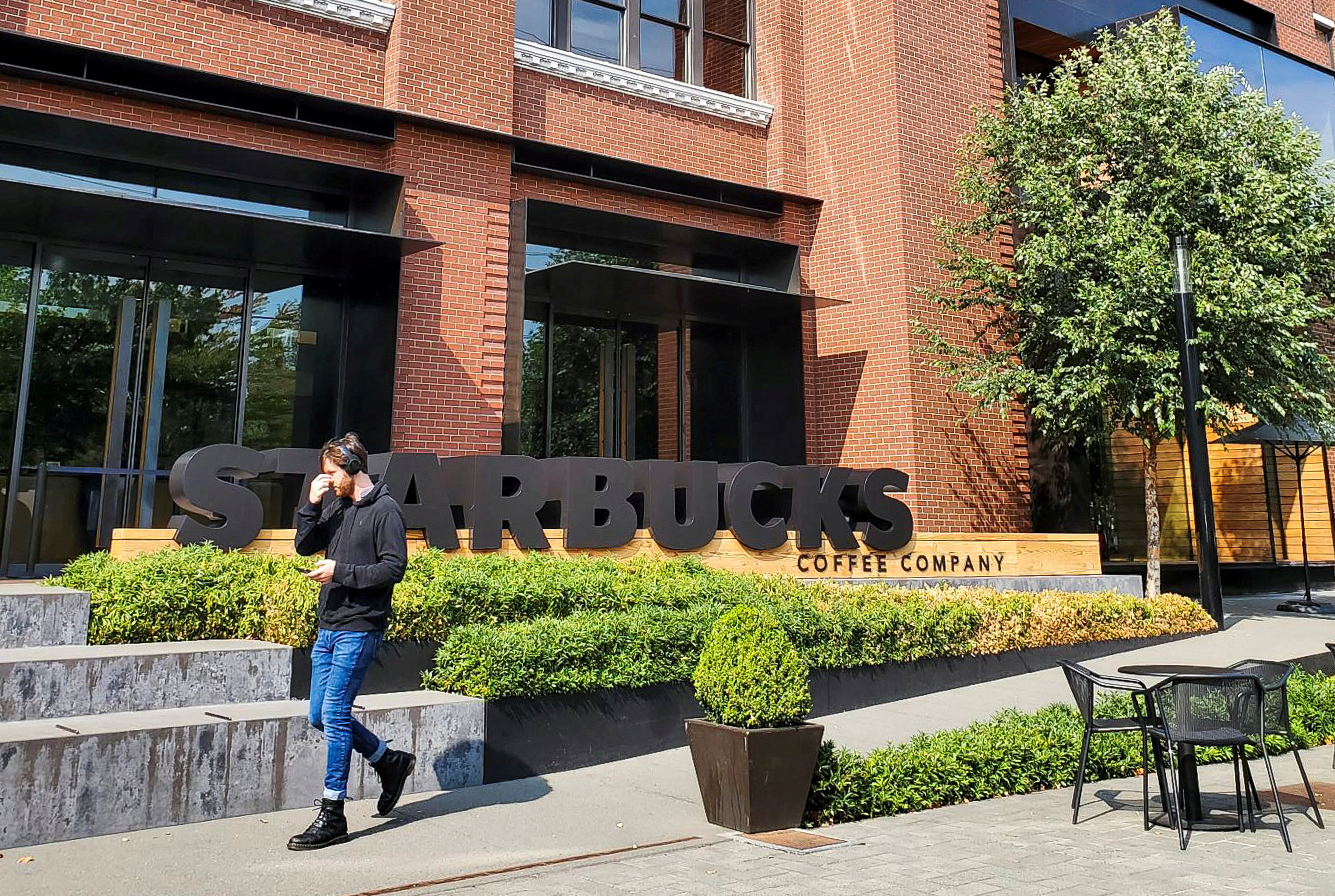 A person walks outside Starbucks headquarters in Seattle, Washington, U.S. September 12, 2022. 