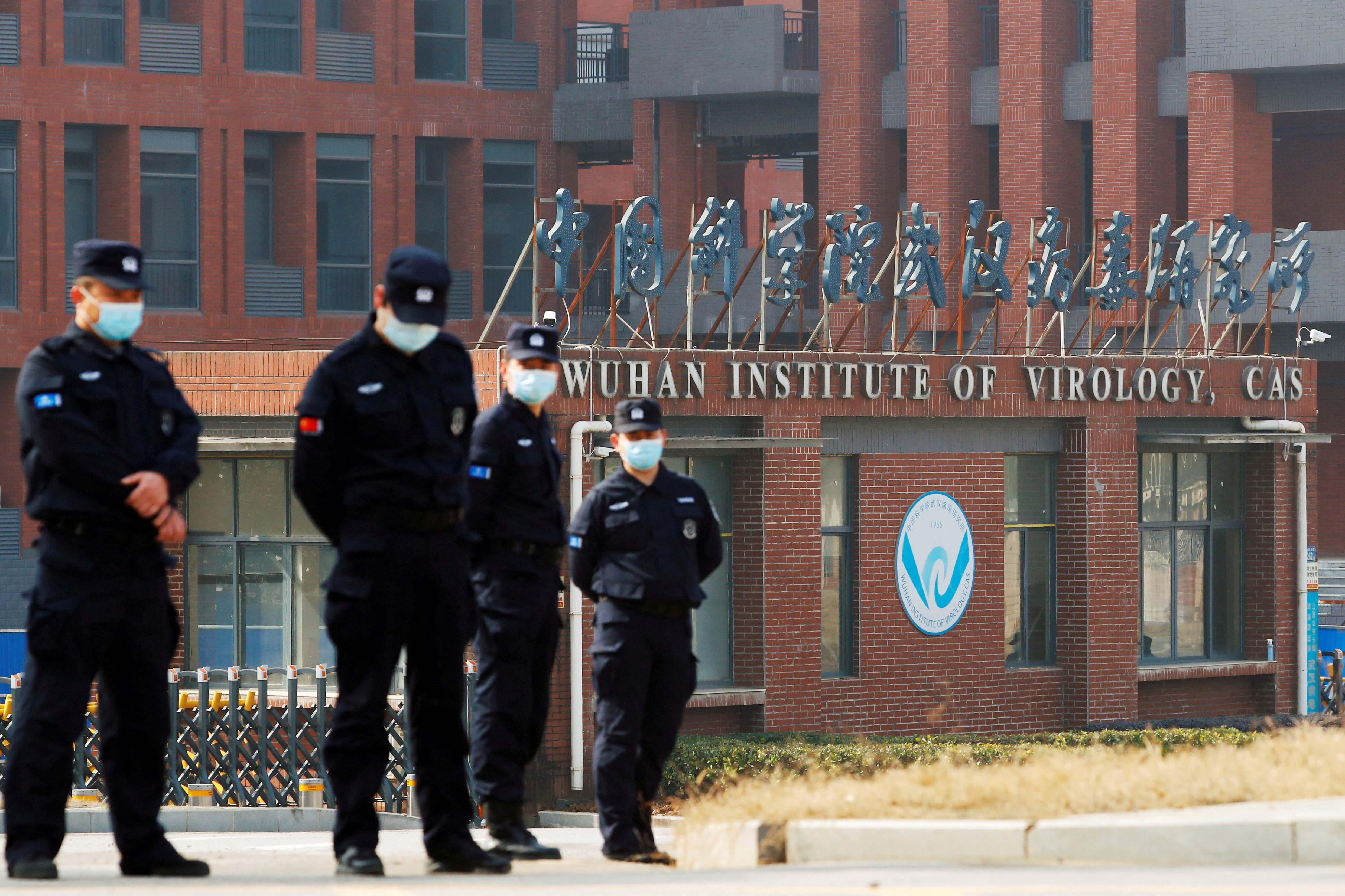 Security personnel keep watch outside Wuhan Institute of Virology during the visit by the World Health Organization (WHO) team tasked with investigating the origins of the coronavirus disease (COVID-19), in Wuhan, Hubei province, China February 3, 2021. REUTERS/Thomas Peter/File Photo