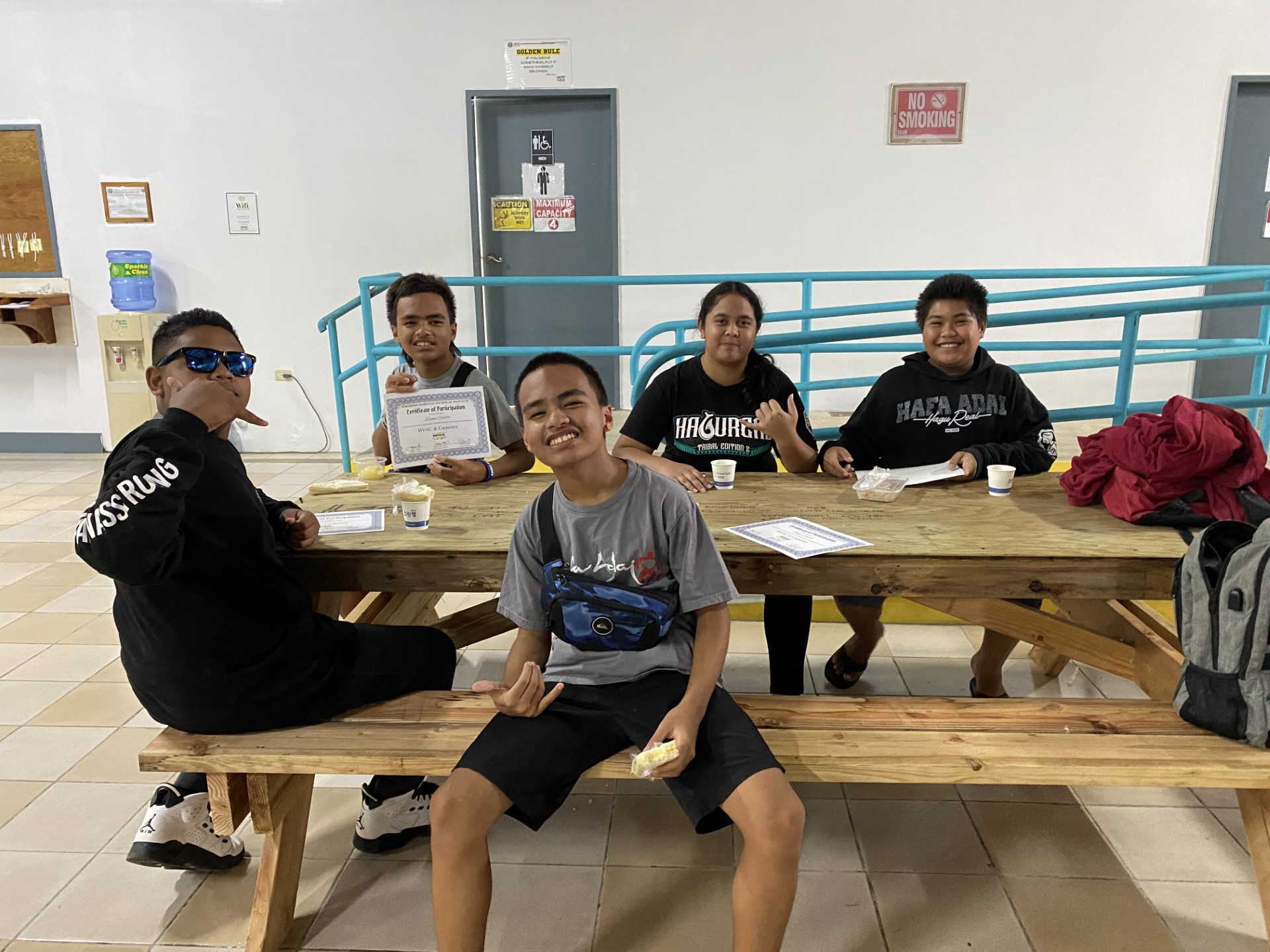 Summer Tech participants enjoy light refreshments at one of the six picnic tables they built. Back row, from left: Zayne Castro, Jolivalyn Kanemoto and Deon Micheal Ogarto-Sablan. Front row, from left, Josiah Quitano and Ziggy Castro.