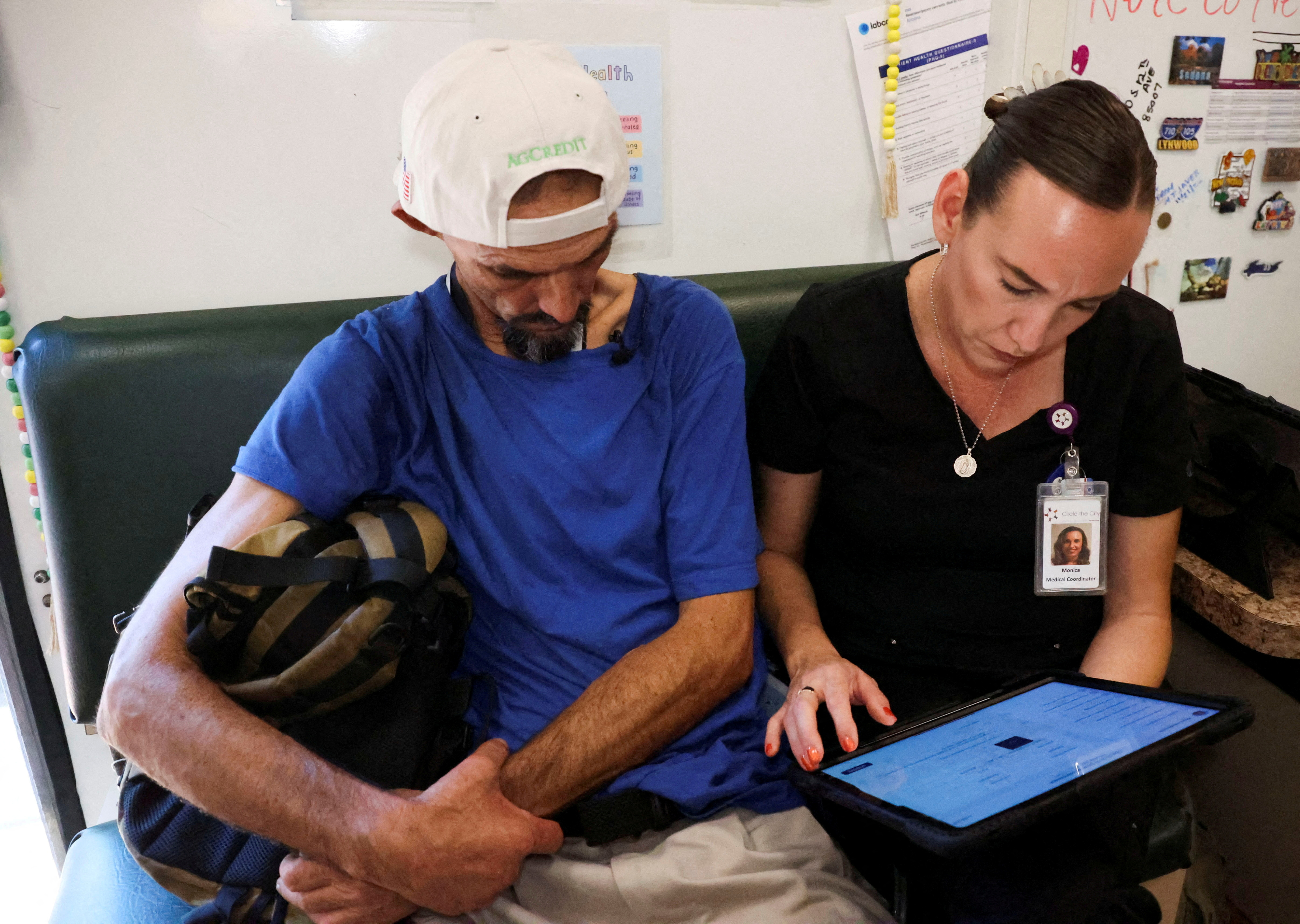 Unhoused people at a downtown Phoenix homeless encampment receive medical care from Circle The City's mobile medical unit on the 14th day of temperatures rising to 110 degrees Fahrenheit, in Phoenix, Arizona, U.S., July 13, 2023. REUTERS/Liliana Salgado/