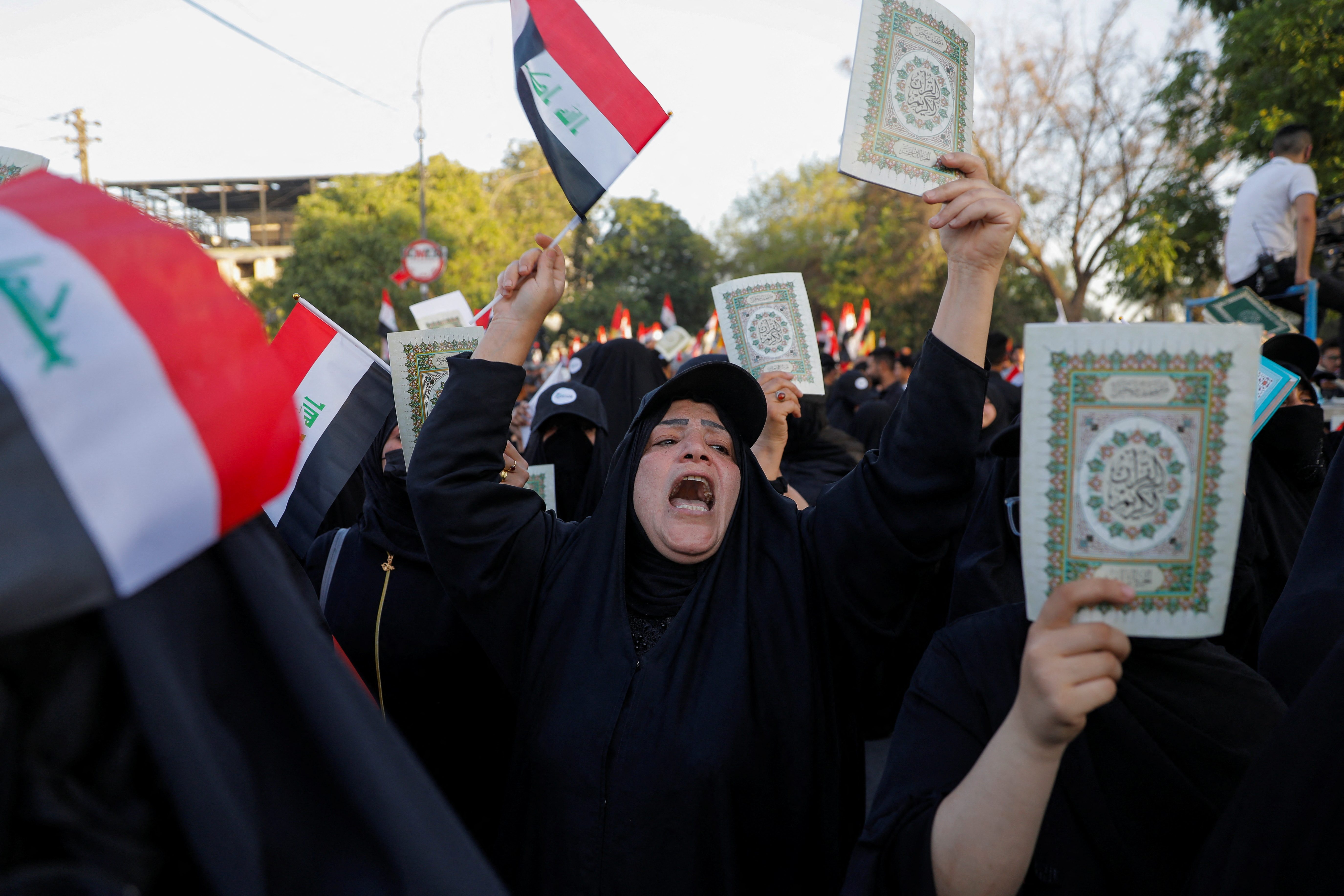 Iraqi demonstrators hold the Koran during a protest near the Green Zone against the burning of a copy of the Koran and the Iraqi flag in the Swedish capital Stockholm, in Baghdad, Iraq July 22, 2023. REUTERS/Khalid Al-Mousily