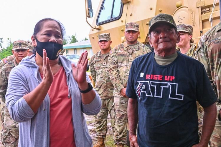 Fely and Sonny Baza thank everyone during a completion ceremony marking the final RISE UP roof repair Thursday, July 27, 2023, outside their home in Dededo.
