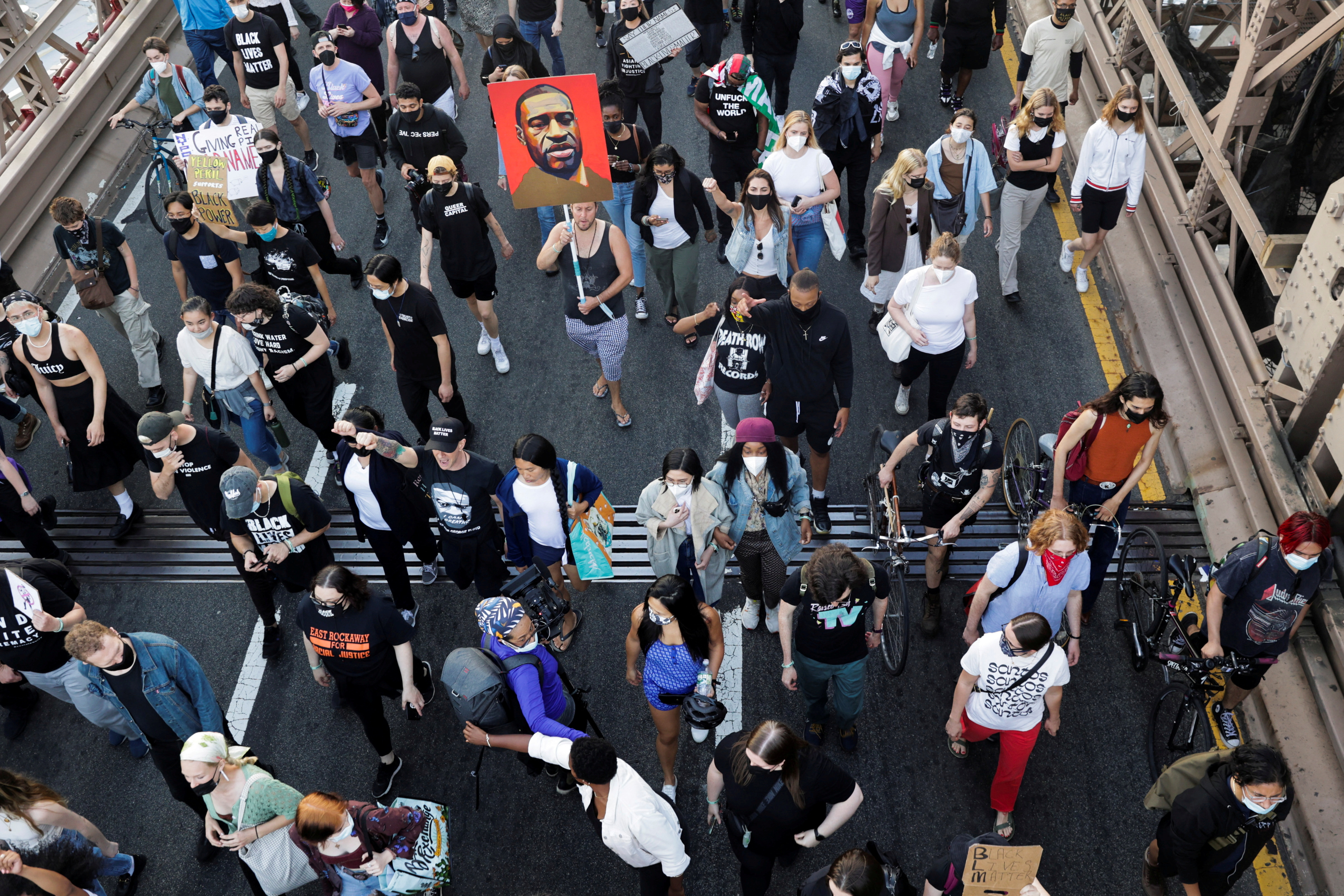 Protesters march on the Brooklyn Bridge during a demonstration on the first anniversary of the death of George Floyd, in New York City, New York, U.S., May 25, 2021. REUTERS/Jeenah Moon/File Photo