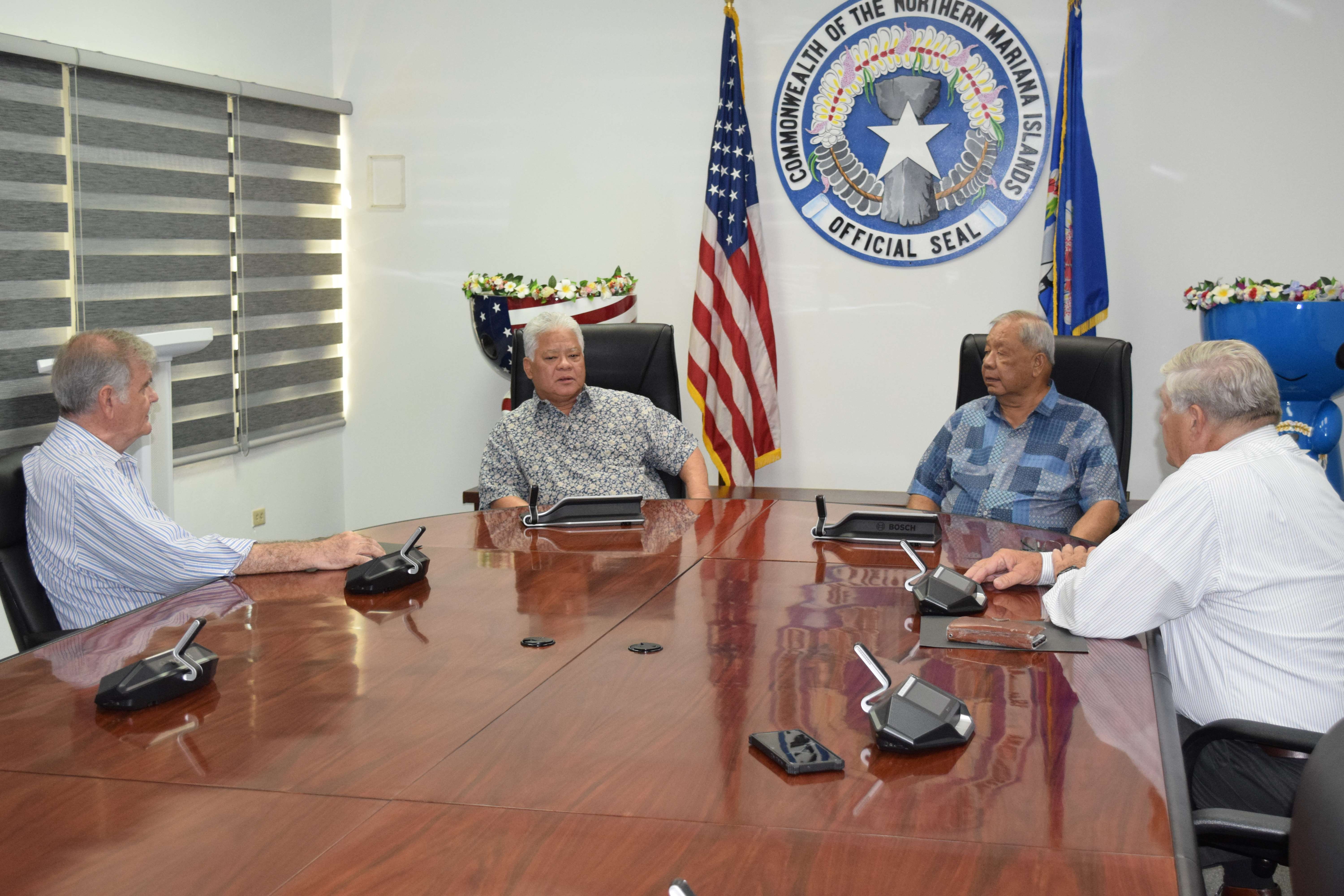 Gov. Arnold I. Palacios, 2nd left, and Lt. Gov. David M. Apatang, second right, discuss utility issues with newly sworn in Commonwealth Public Utilities Commission members Dr. John "Jack" Angello, left, and attorney James Sirok, right, in the governor's conference room on Friday.