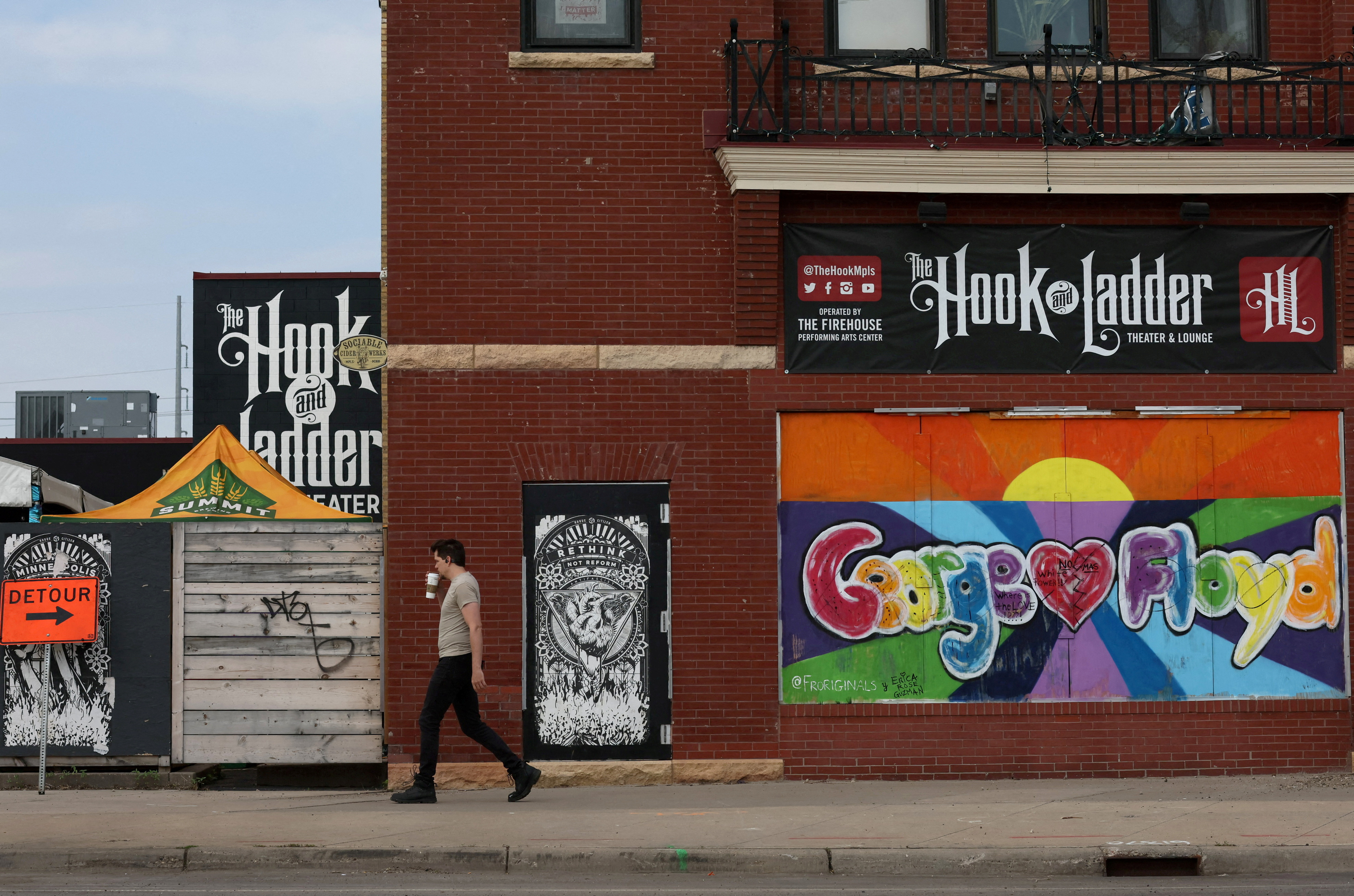 A pedestrian walks past a mural near the closed Minneapolis 3rd Police Precinct on the third anniversary of the murder of George Floyd by a police officer in Minneapolis, Minnesota, U.S., May 25, 2023. REUTERS/Leah Millis/File Photo