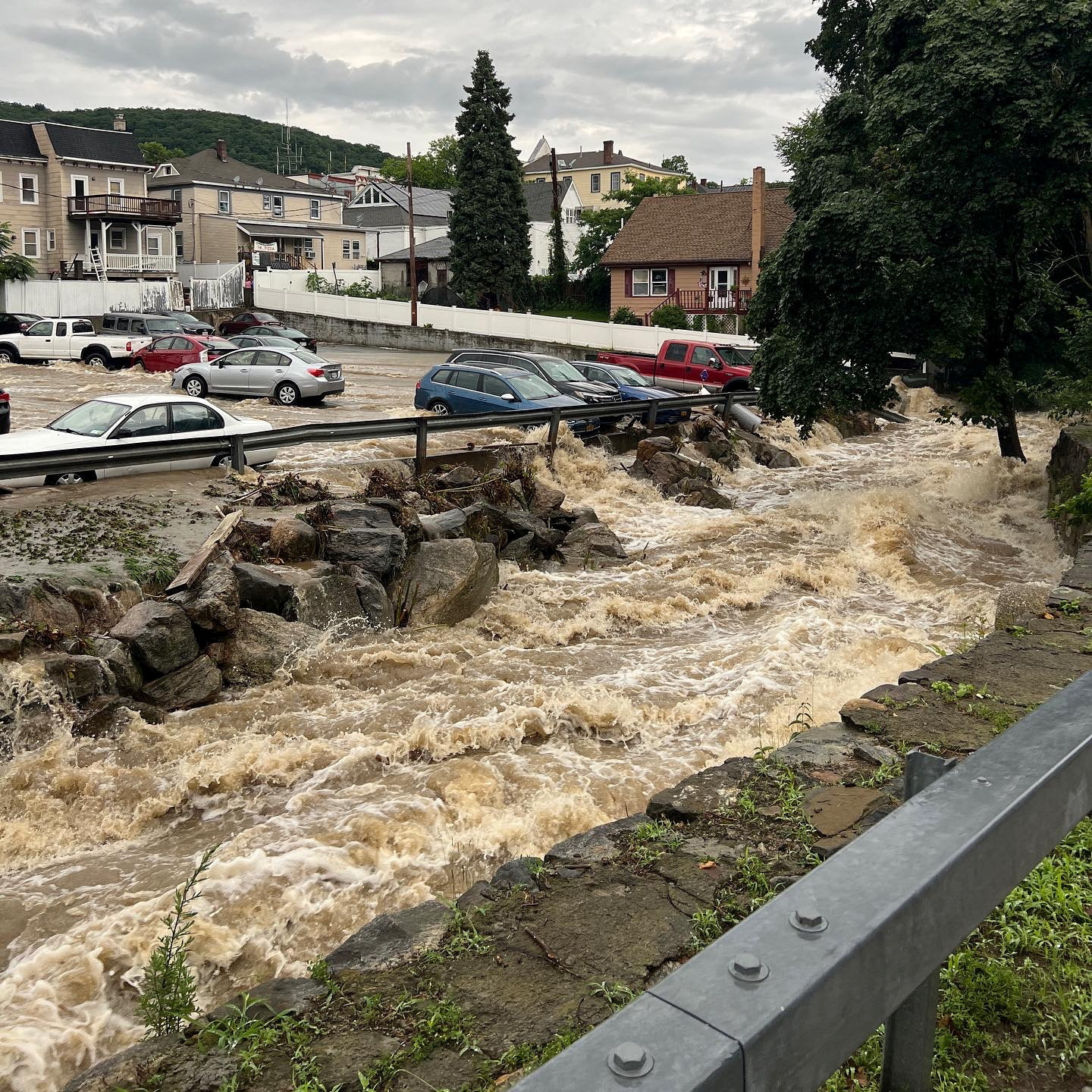 Flooding surrounds a parking lot, in Highland Falls, Orange County, New York, U.S., July 9, 2023, in this still image from video obtained from social media. Marc Zahakos /via REUTERS