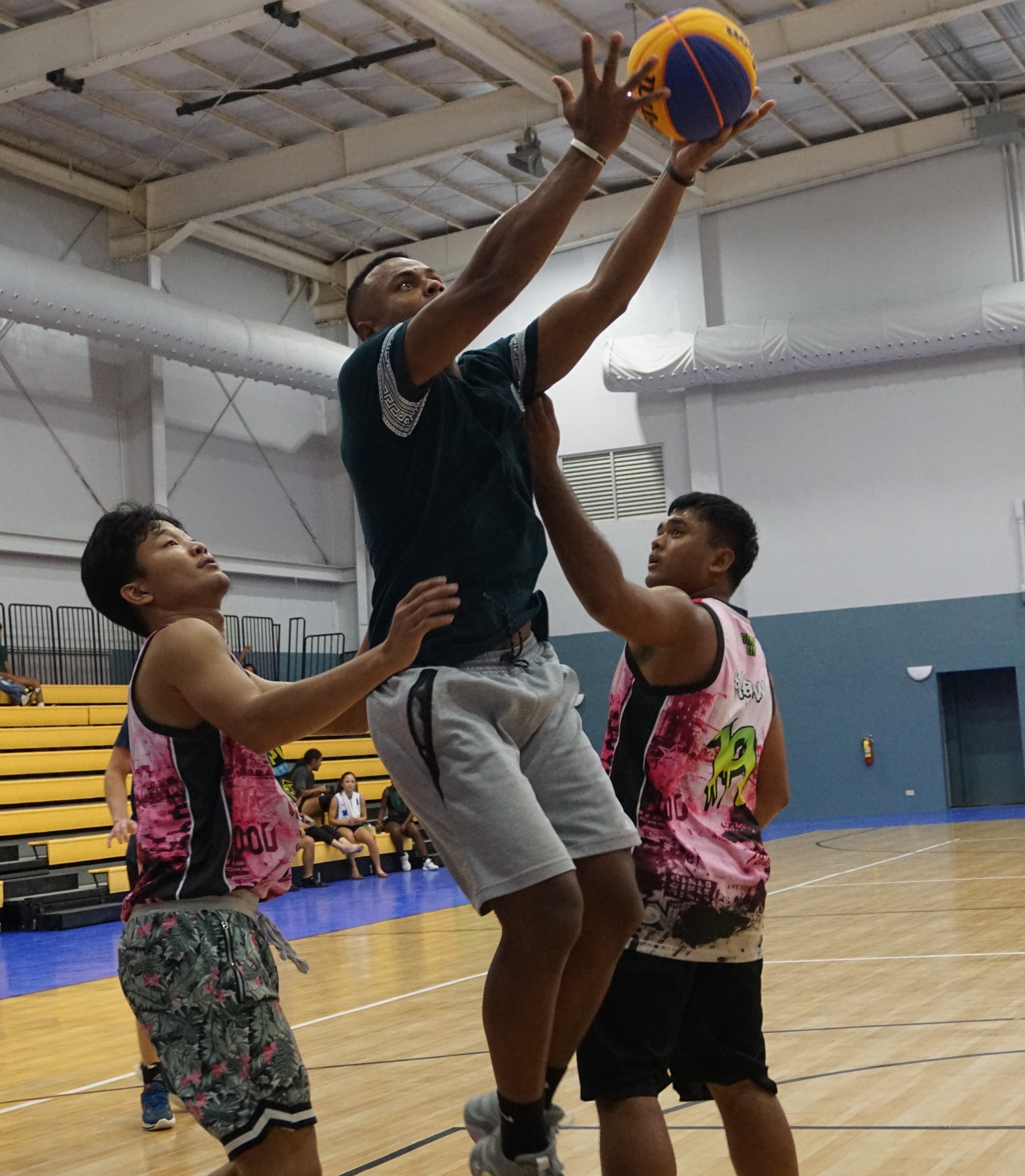 Pohnpei 1's Connor Boylan goes up for the finish against two defenders during the men's division 3x3 championship match of the 2023 NMI-Pohnpei Goodwill Basketball Games on Friday at the Ada gym.