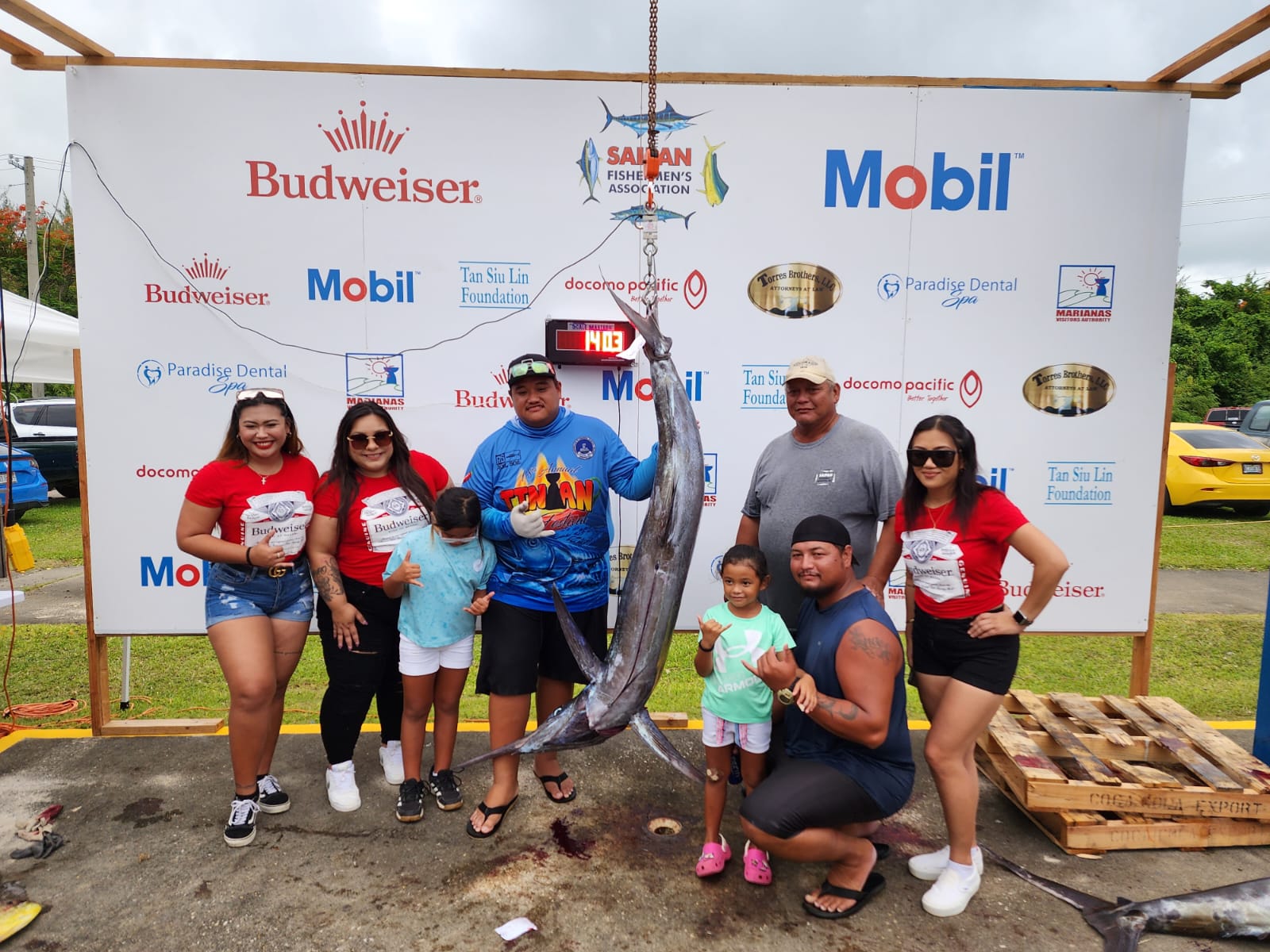 Botin Saba’s crewmembers and the Marpac Bud Girls  pose  with the winning marlin that weighed 140.3 pounds during the Saipan Fishermen's Association 39th Saipan International Fishing Tournament on Sunday at Smiling Cove Marina.