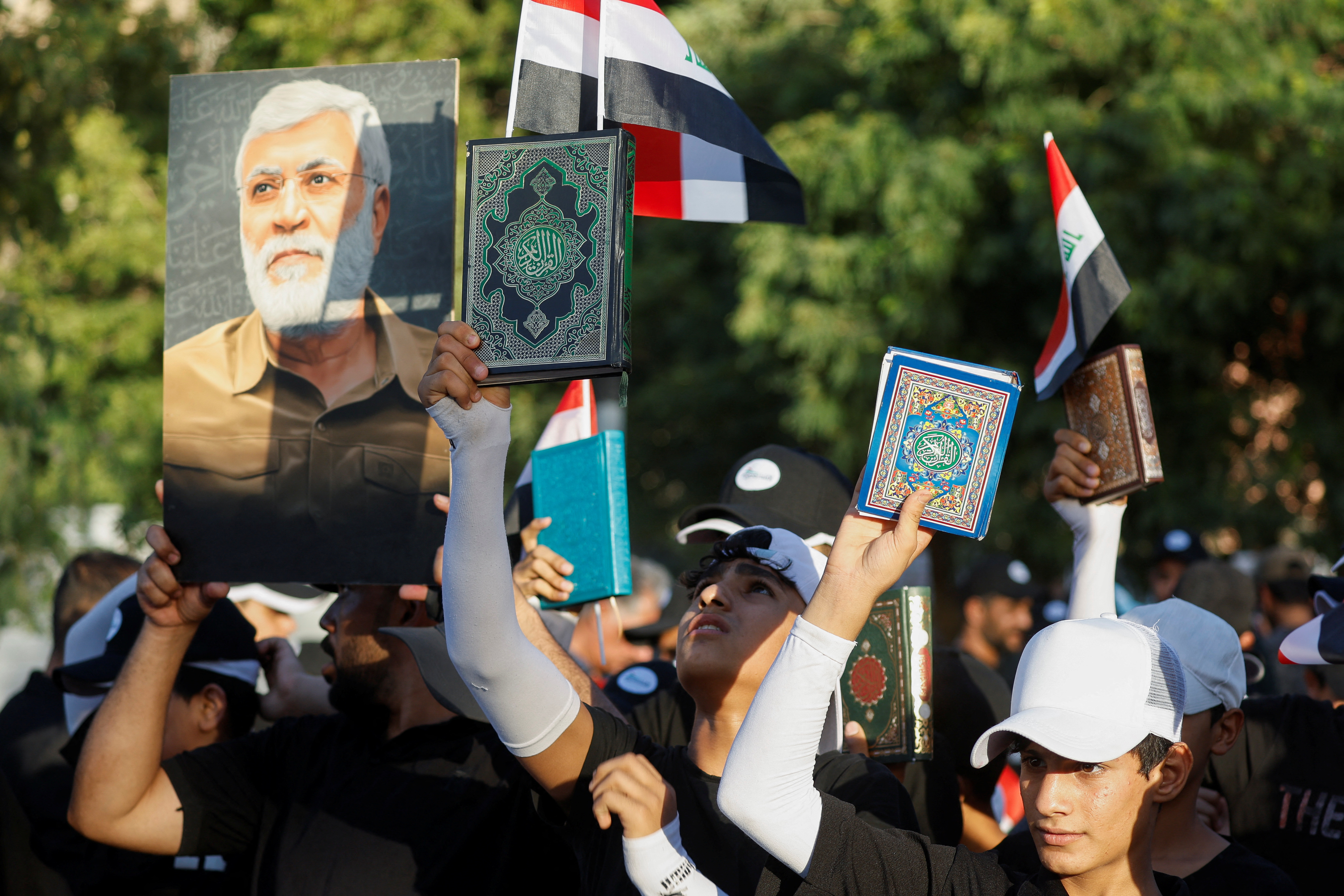 Iraqi demonstrators hold the Koran during a protest near the Green Zone against the burning of a copy of the Koran and the Iraqi flag in the Swedish capital Stockholm, in Baghdad, Iraq July 22, 2023. REUTERS/Khalid Al-Mousily
