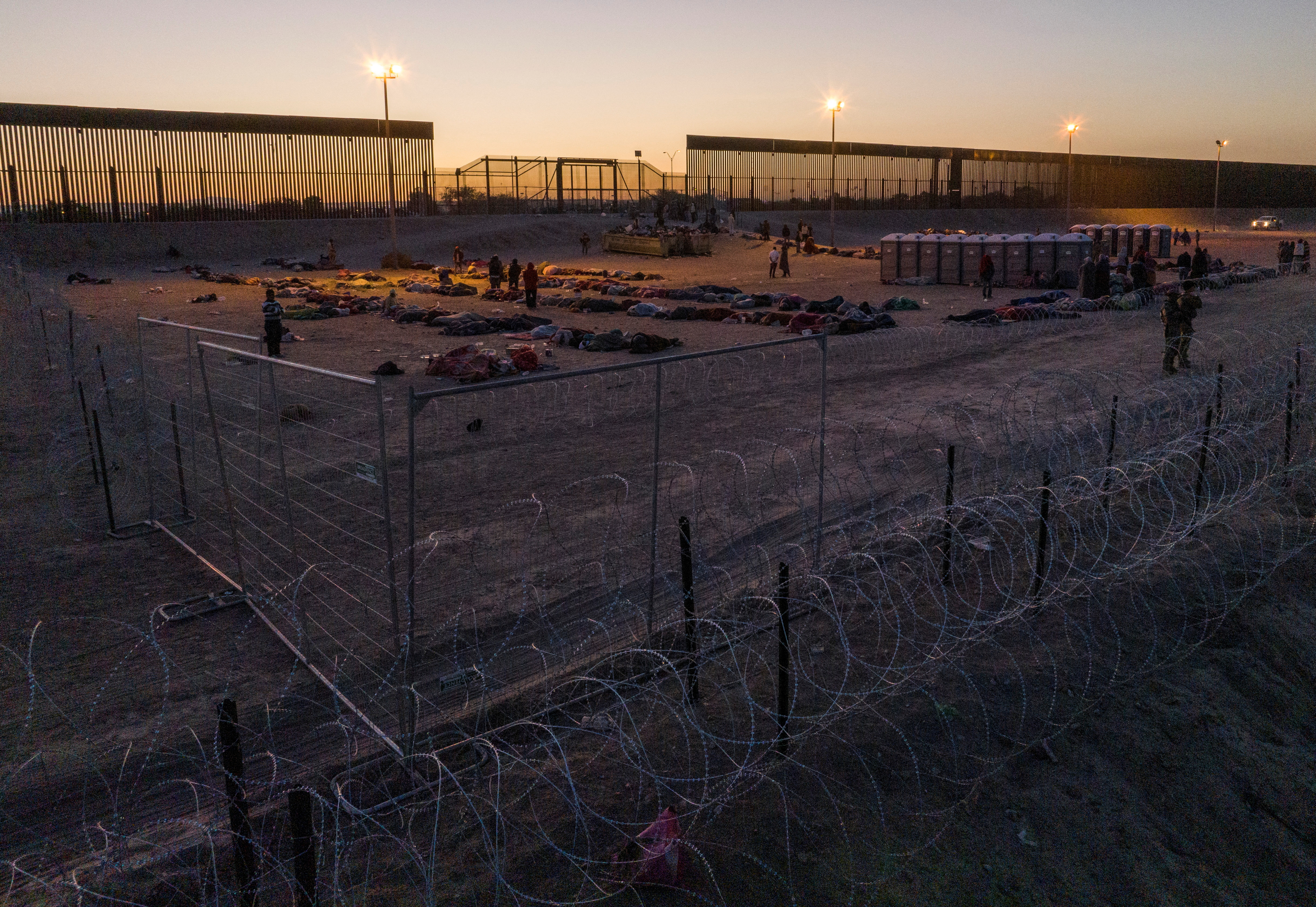 Migrants are seen gathered on the U.S.-Mexico border at sunrise after the lifting of Title 42 near El Paso, Texas, U.S., May 12, 2023. REUTERS/Julio Cesar Chavez