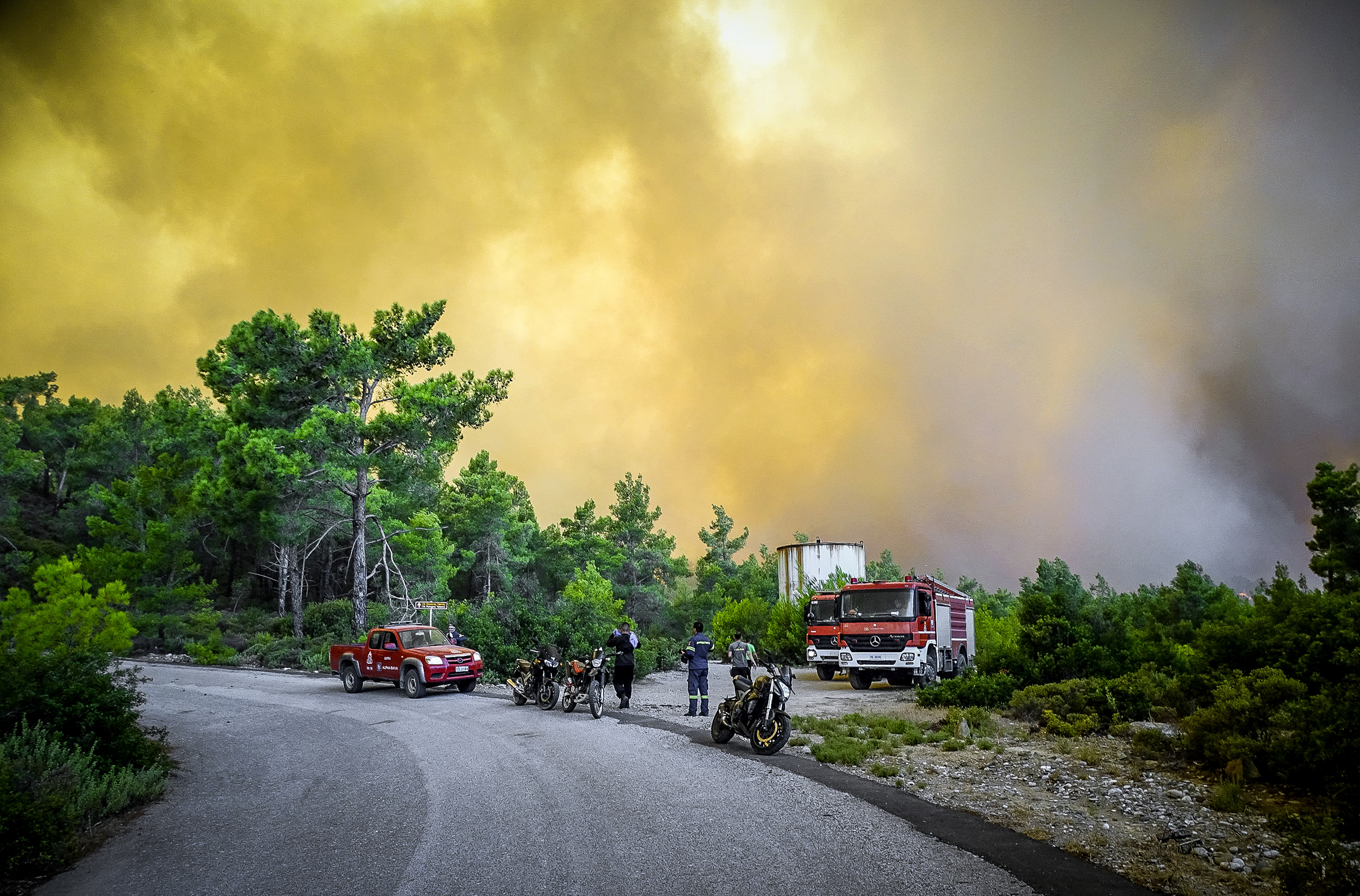 Firefighters are seen near a wildfire on the island of Rhodes, Greece, July 22, 2023. Argiris Mantikos/Eurokinissi via REUTERS
