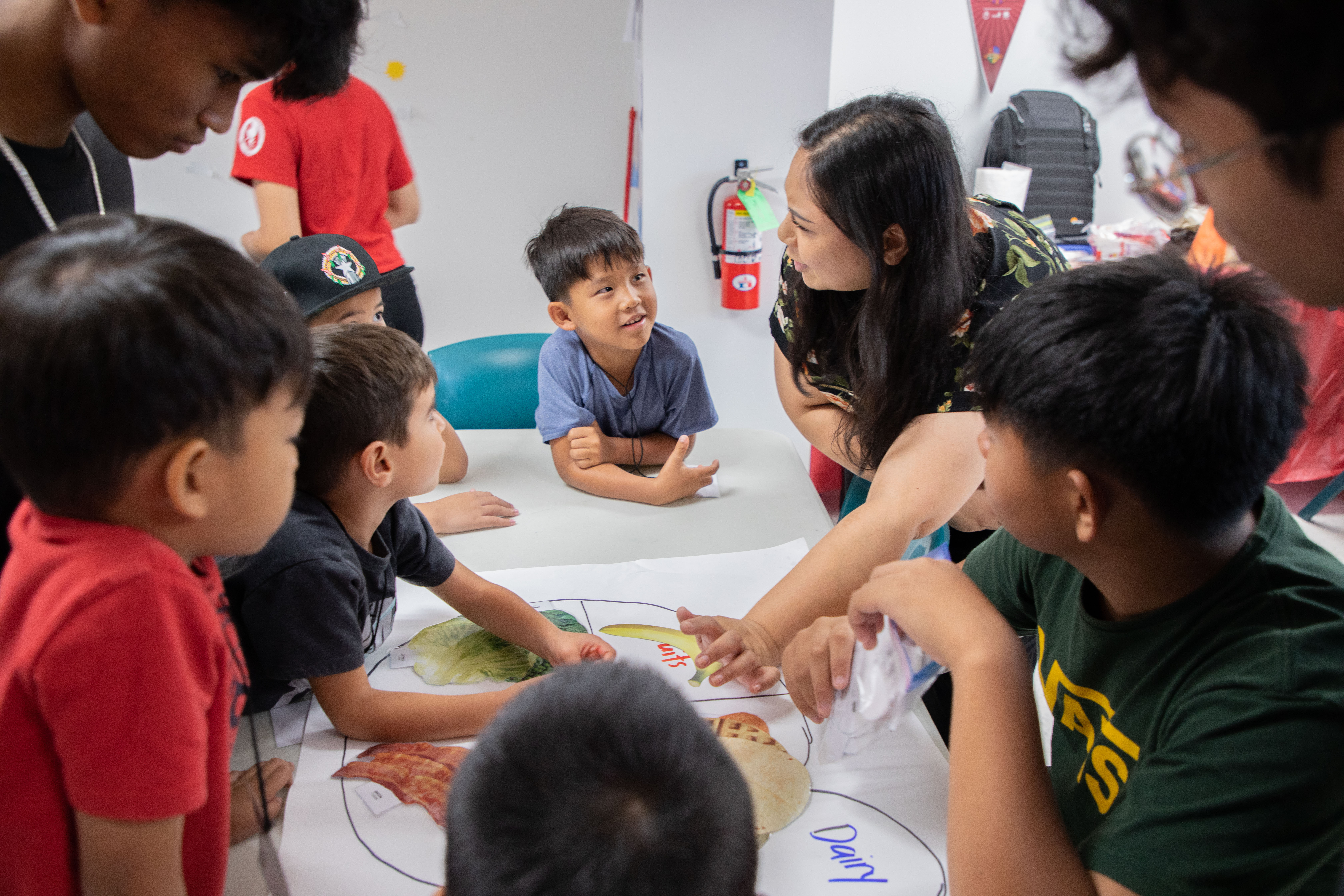 A camper listens attentively as Ashley Sikayun from Northern Marianas College's Cooperative Research, Extension, and Education Services talks about the importance of proper nutrition and food groups.