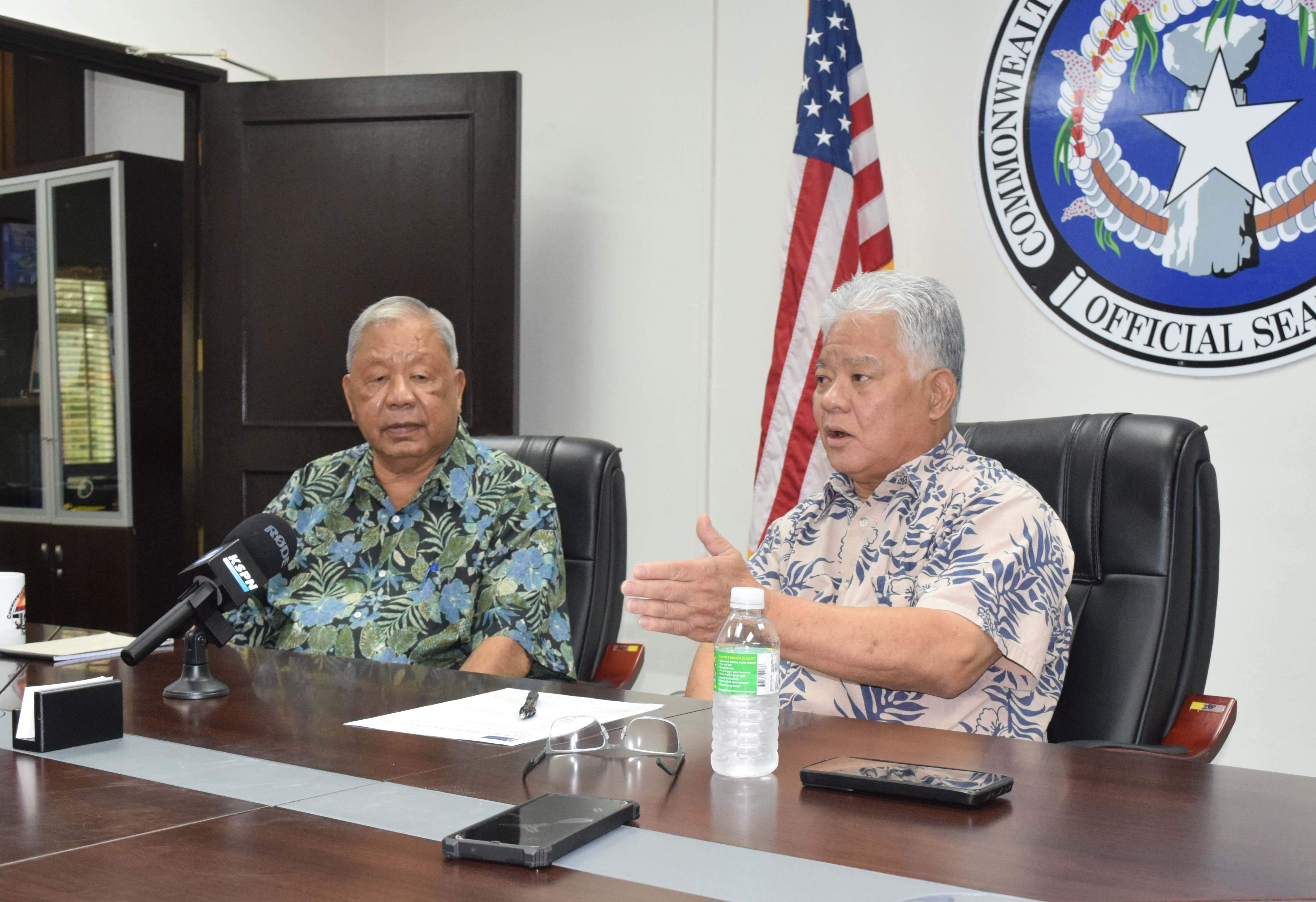 Gov. Arnold I. Palacios, right, gestures as he speaks to reporters while  Lt. Gov. David M. Apatang listens during a press conference at the governor's office on Monday.